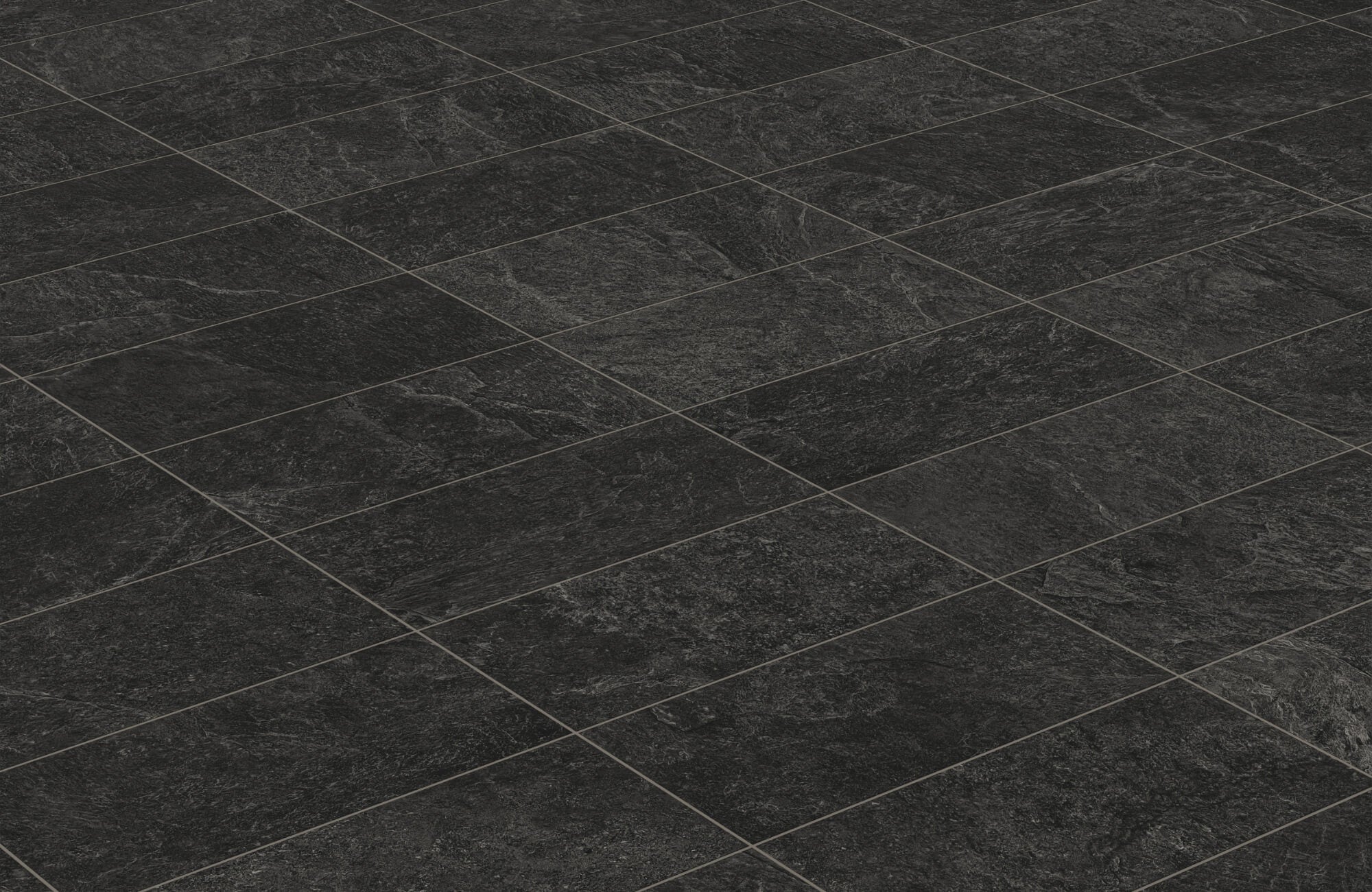 Close-up view of matte black floor tiles with subtle texture and dark grout lines arranged in a grid pattern under soft lighting.