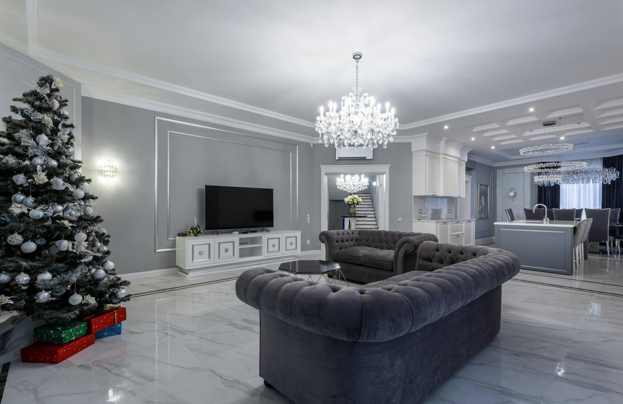 null Elegant living room with glossy marble flooring, chandelier lighting, and neutral furnishings emphasizing smooth, reflective finish.