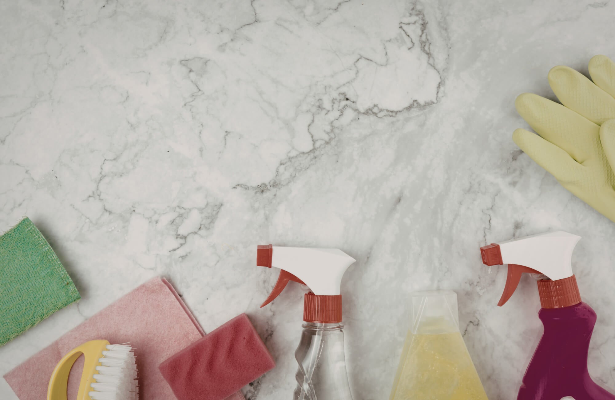 null Cleaning supplies on marble surface, illustrating proper maintenance practices to preserve durability and prevent surface damage.