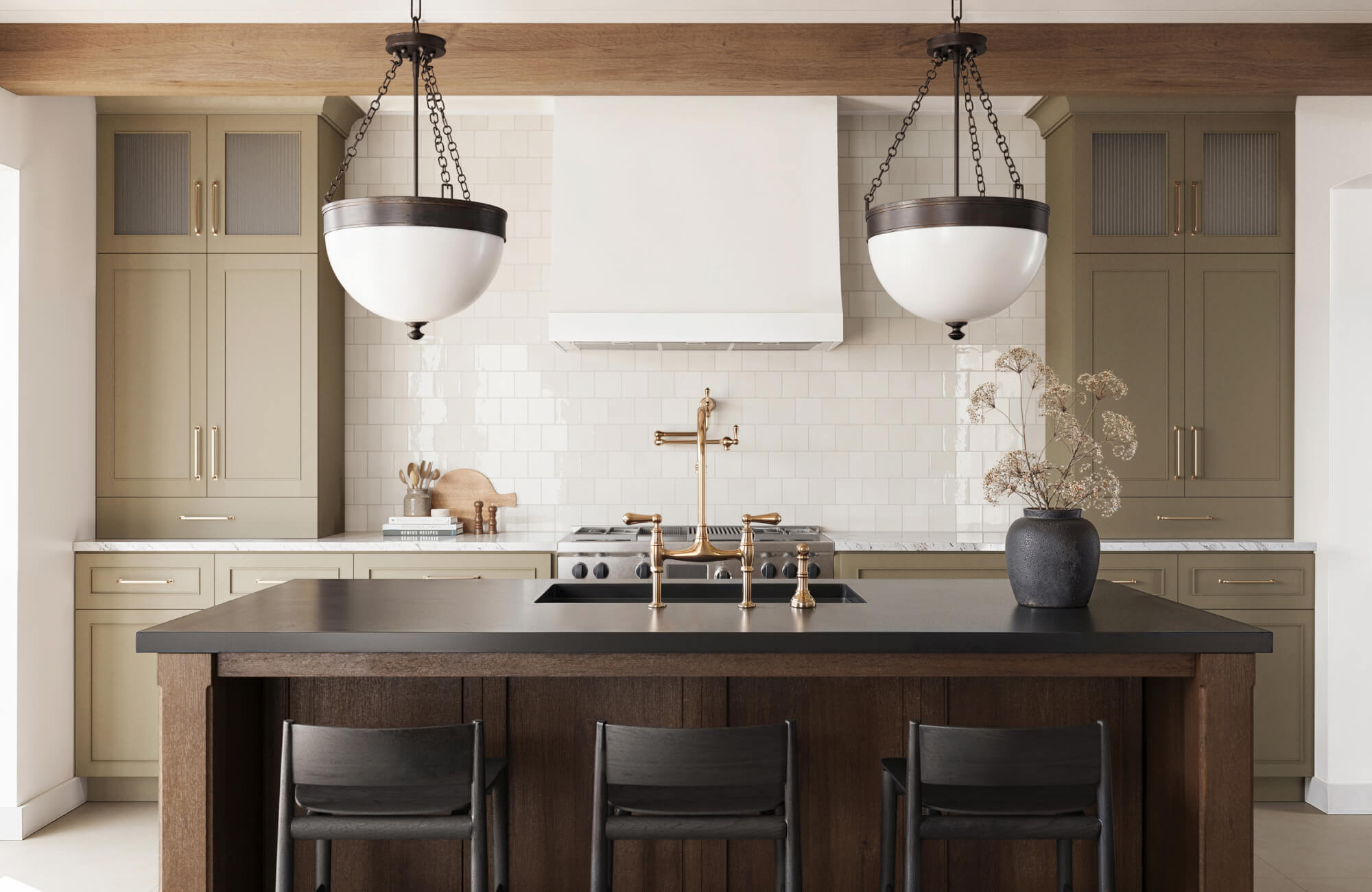 null Transitional kitchen with dome pendant lights, brass fixtures, olive cabinetry, and a dark island with black seating and neutral tile backsplash.