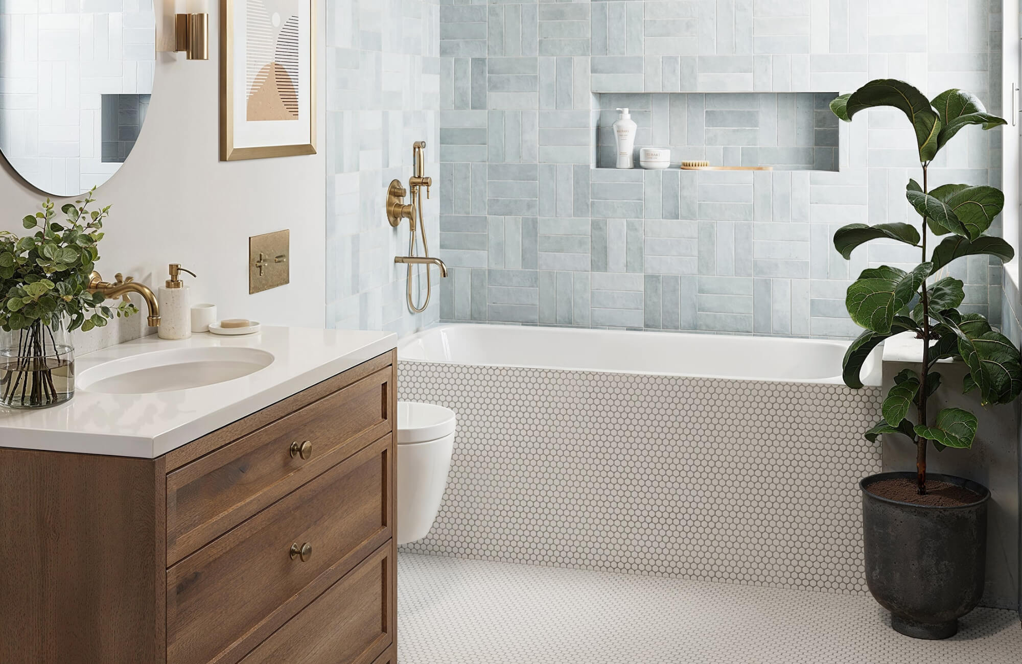 Bathroom with a wood vanity, blue wall tiles, and white penny tile flooring extending onto the bathtub surround.