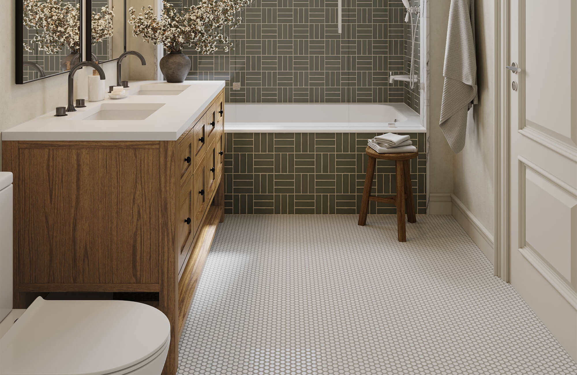 Bathroom with warm wood cabinetry, green wall tiles, and light gray penny tile flooring across the entire space.