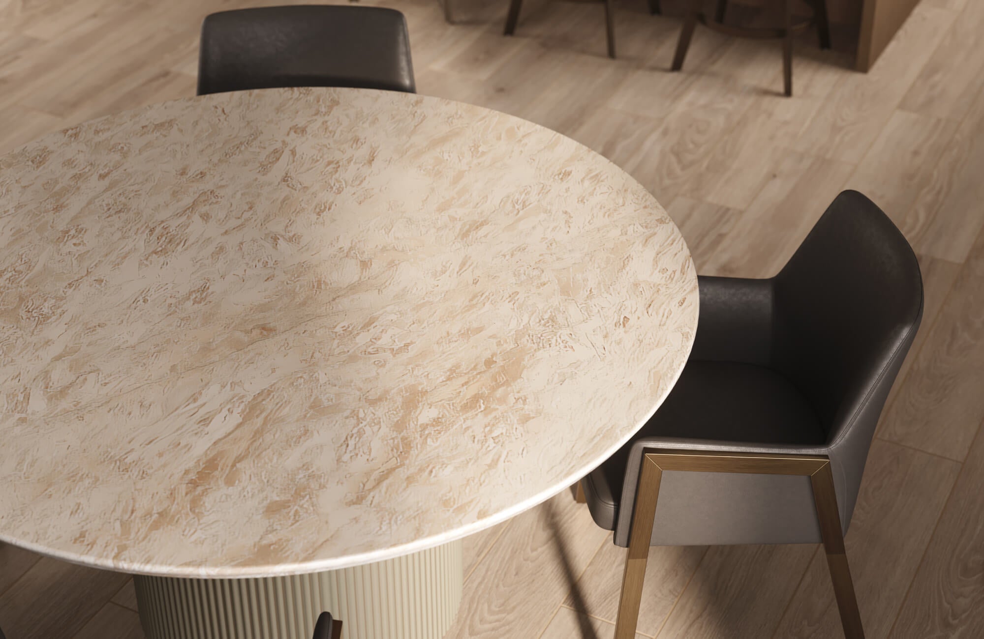 null Close-up of a round dining table with a textured beige marble top and fluted base, paired with sleek leather armchairs.