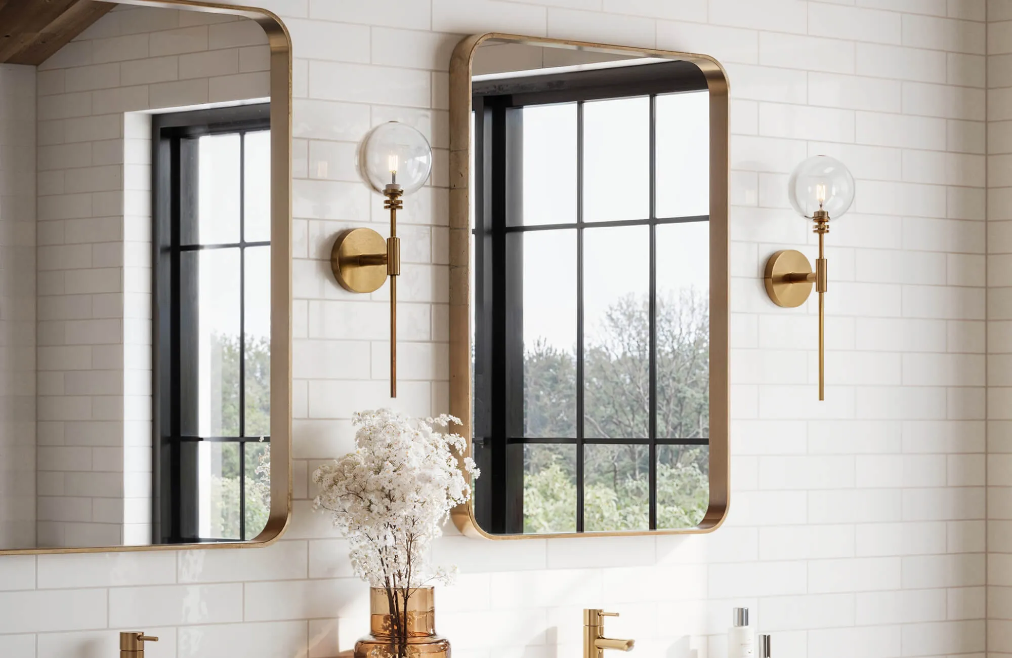 Sleek white subway tiles with a glossy finish create a bright, timeless backdrop in this modern double vanity bathroom.