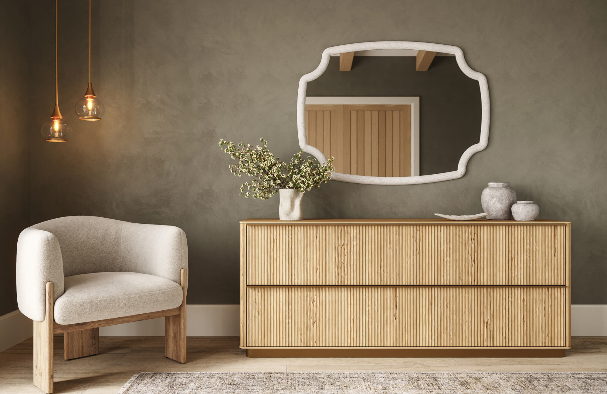Minimalist living room with wood sideboard, sculptural mirror, textured wall, lounge chair, and pendant lights in warm neutral tones.