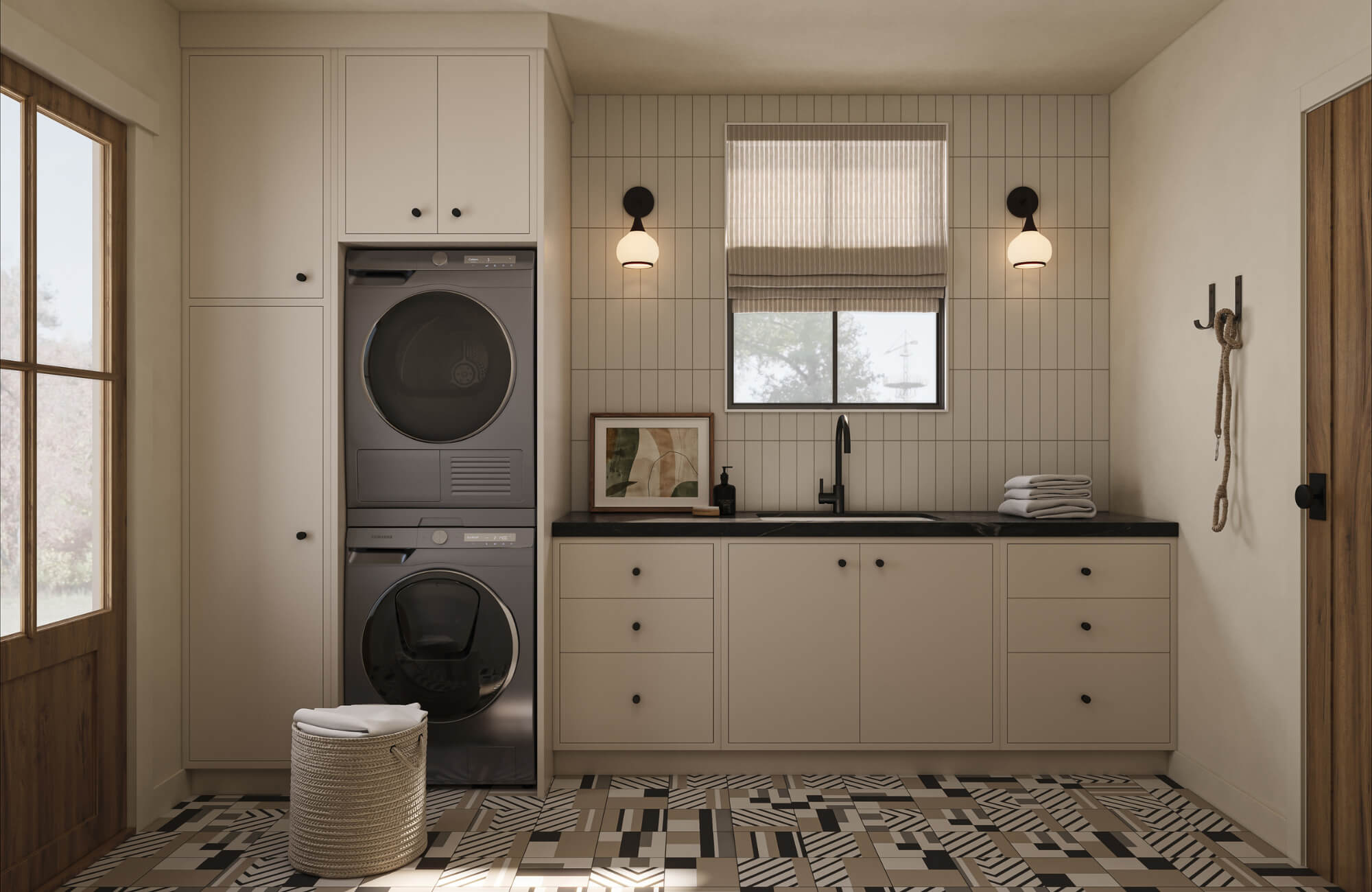 Bright laundry room with stacked washer dryer, beige cabinetry, patterned tile floor, black faucet sink, and modern wall sconces.