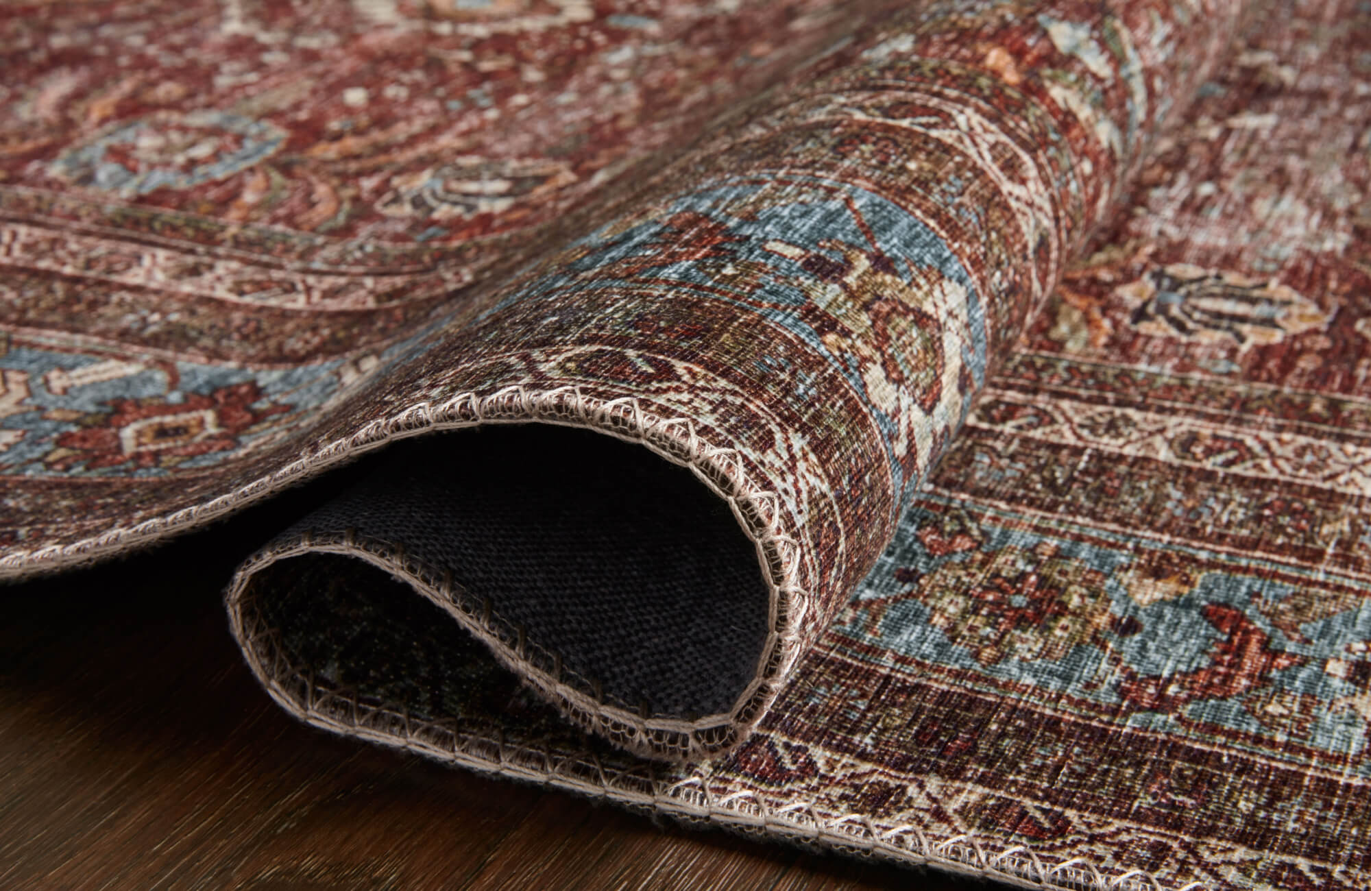 null Close-up of vintage-style rug corner, detailed distressed pattern and bound edges revealing low-pile texture and durable backing.