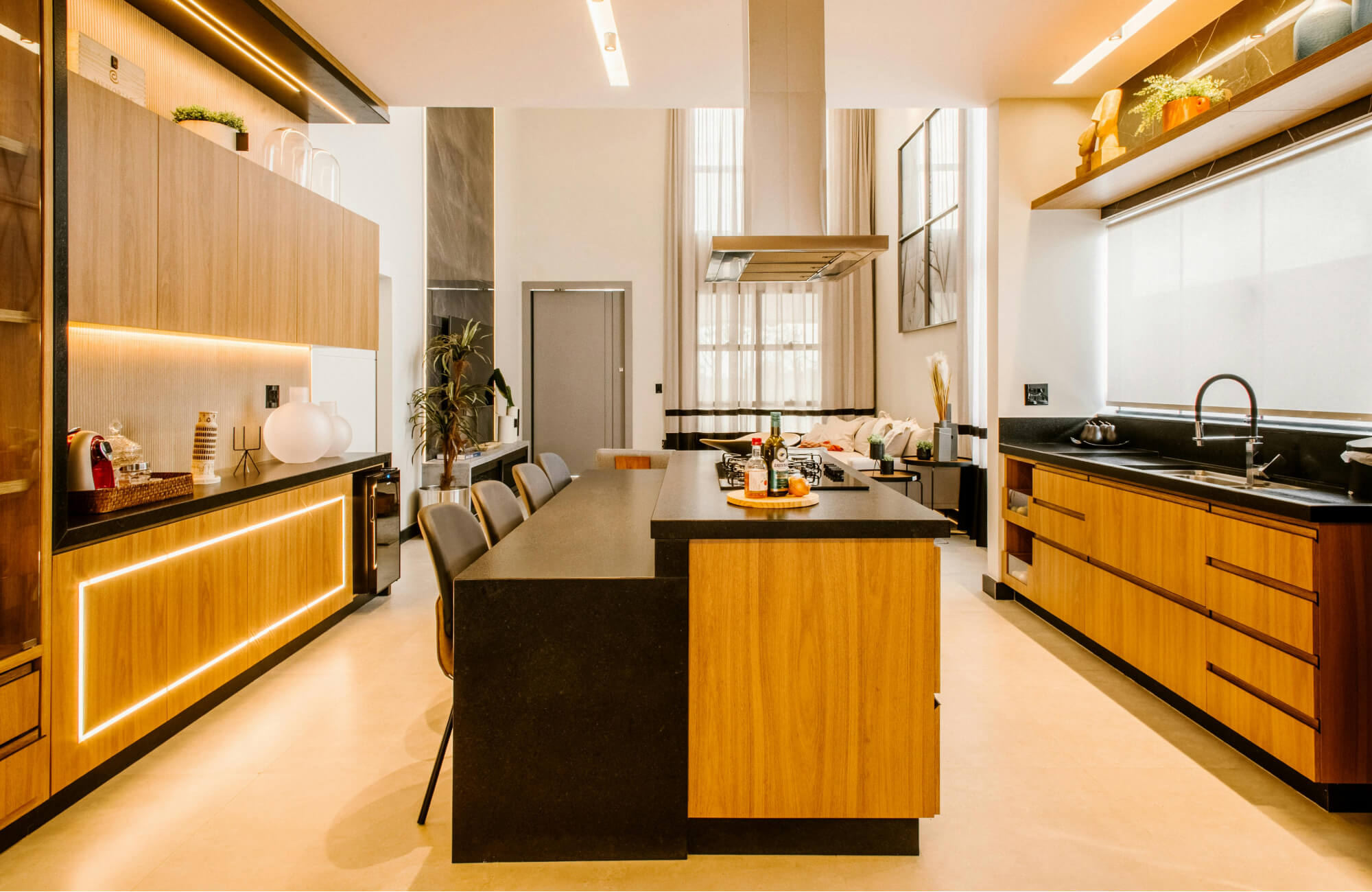 null Contemporary galley kitchen with mixed wood and black finishes, sleek lighting, and a central island anchoring the space.