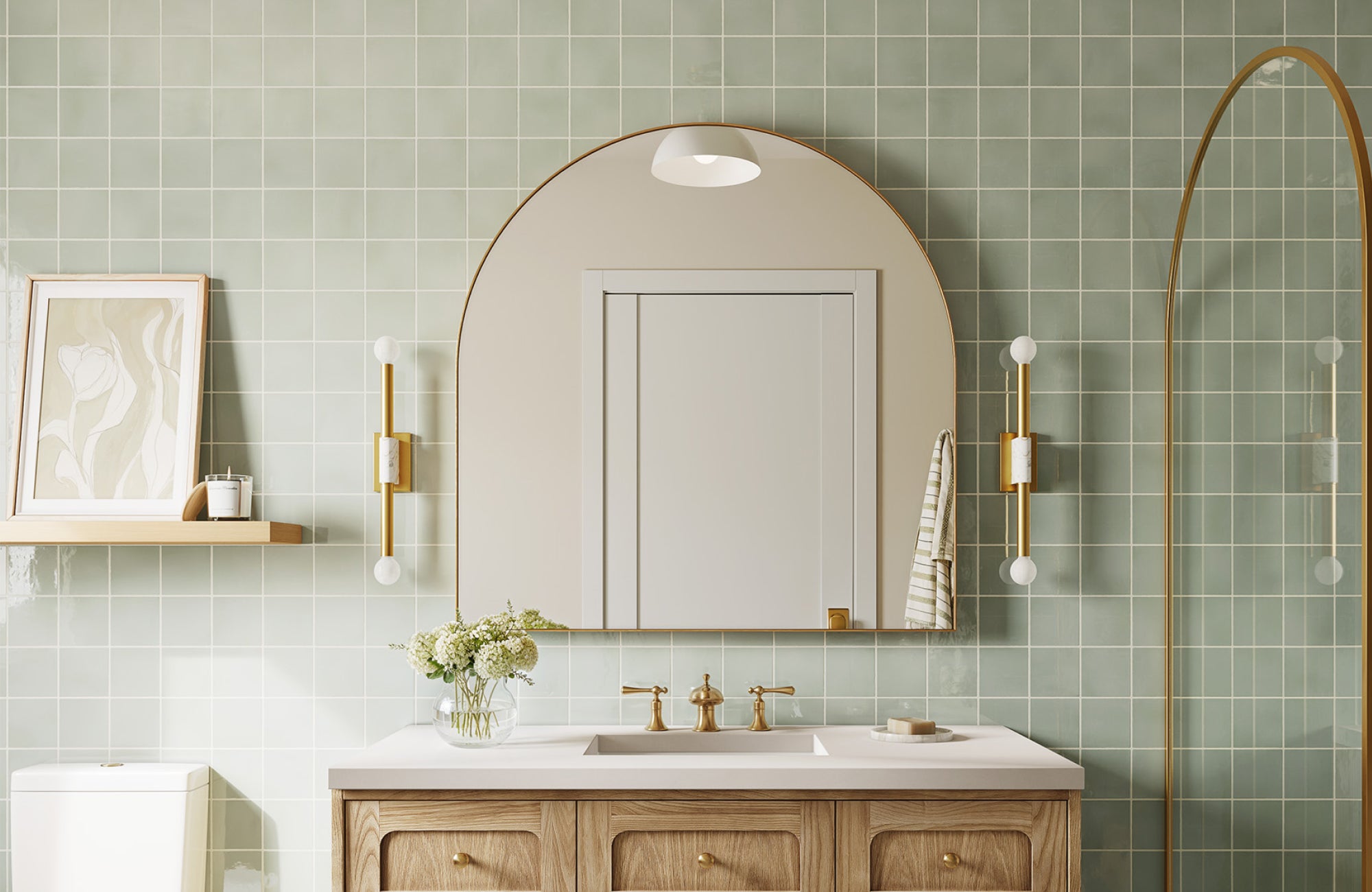 Slim vertical sconces beside a large arched mirror, fitting comfortably within the vanity’s width.