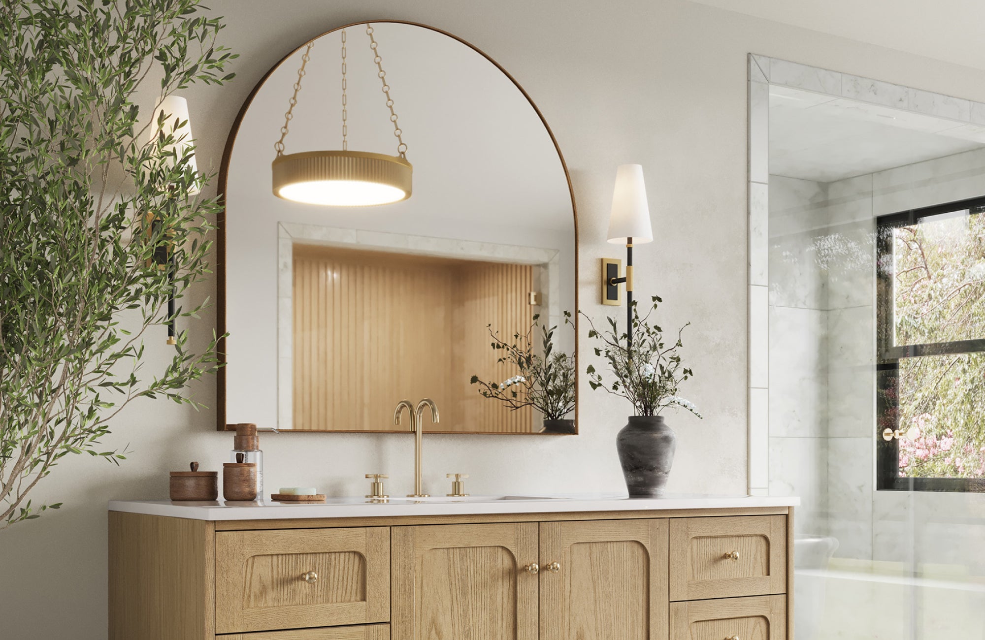 Large arched mirror over a 60-inch vanity with sconces on each side, creating balanced lighting and an elegant focal point.