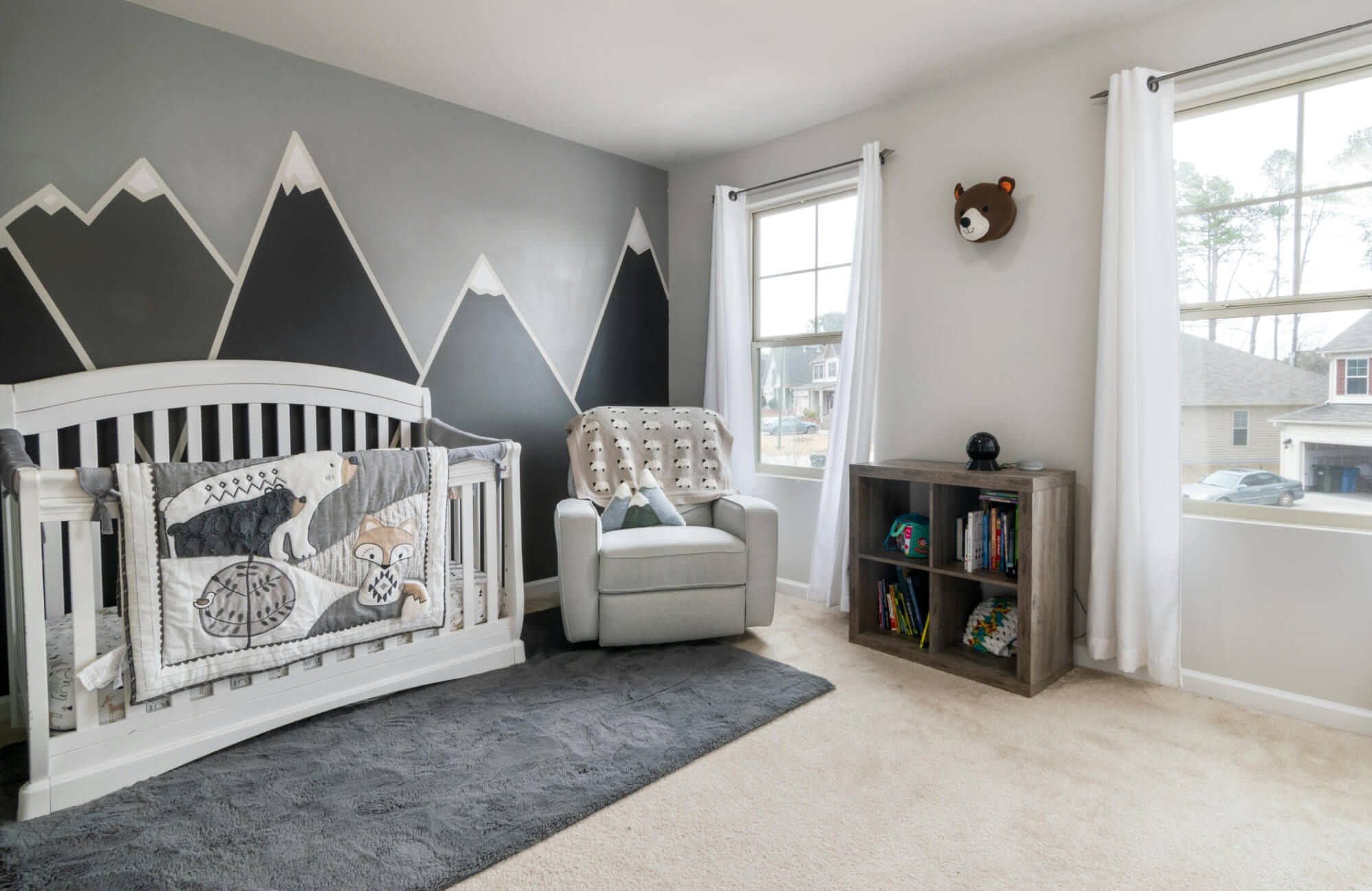 Plush rug positioned under crib and chair, offering cushioned support in high use areas while avoiding wall edges.