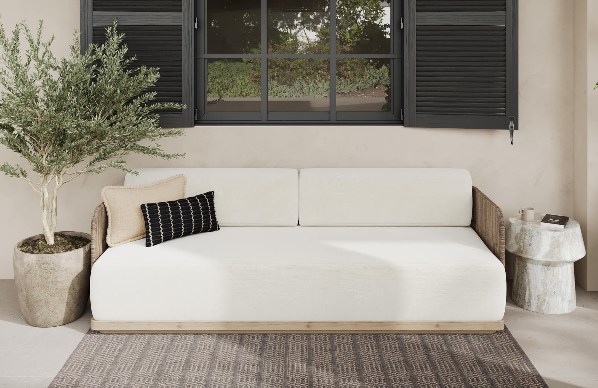 null A small lumbar pillow adds subtle support on the wide outdoor sofa while keeping the seating area open and uncluttered.