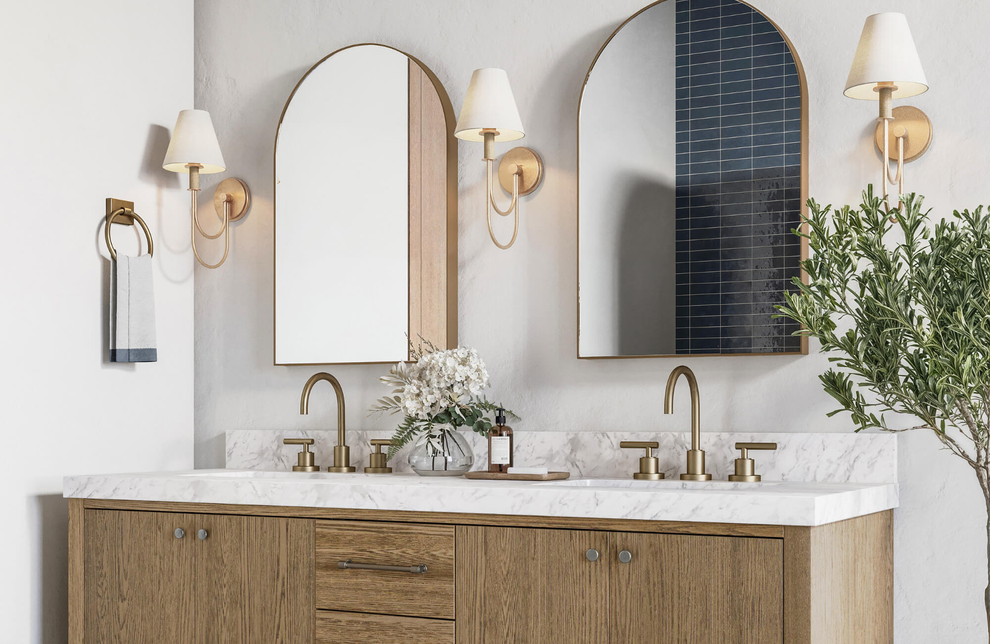 null Contemporary bathroom with dual arched mirrors, gold fixtures, shaded sconces, and a wood vanity topped with white marble.