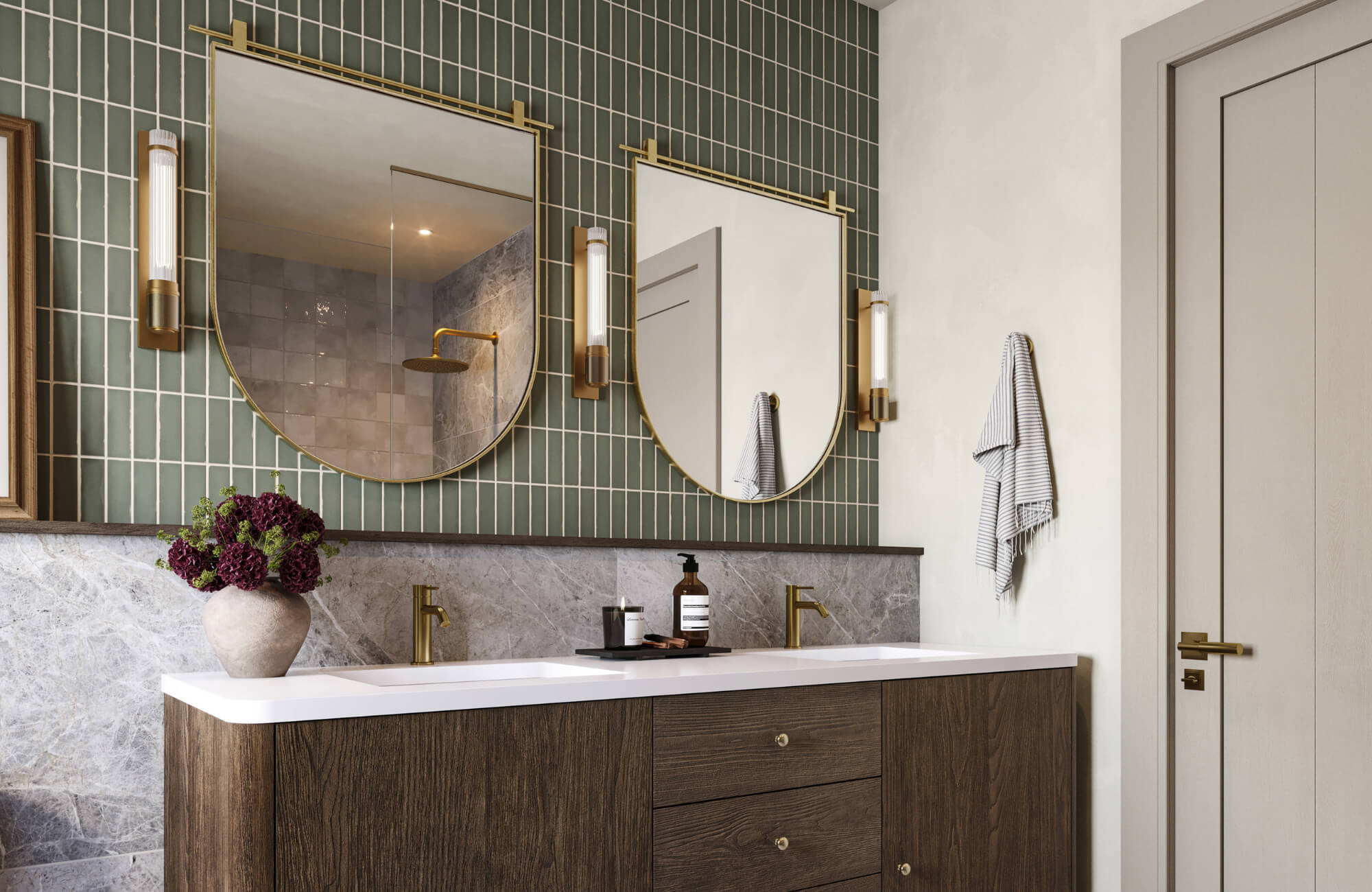 null Bathroom with double vanity, two arched gold-framed mirrors, green tiled wall, marble backsplash, and modern brass fixtures.