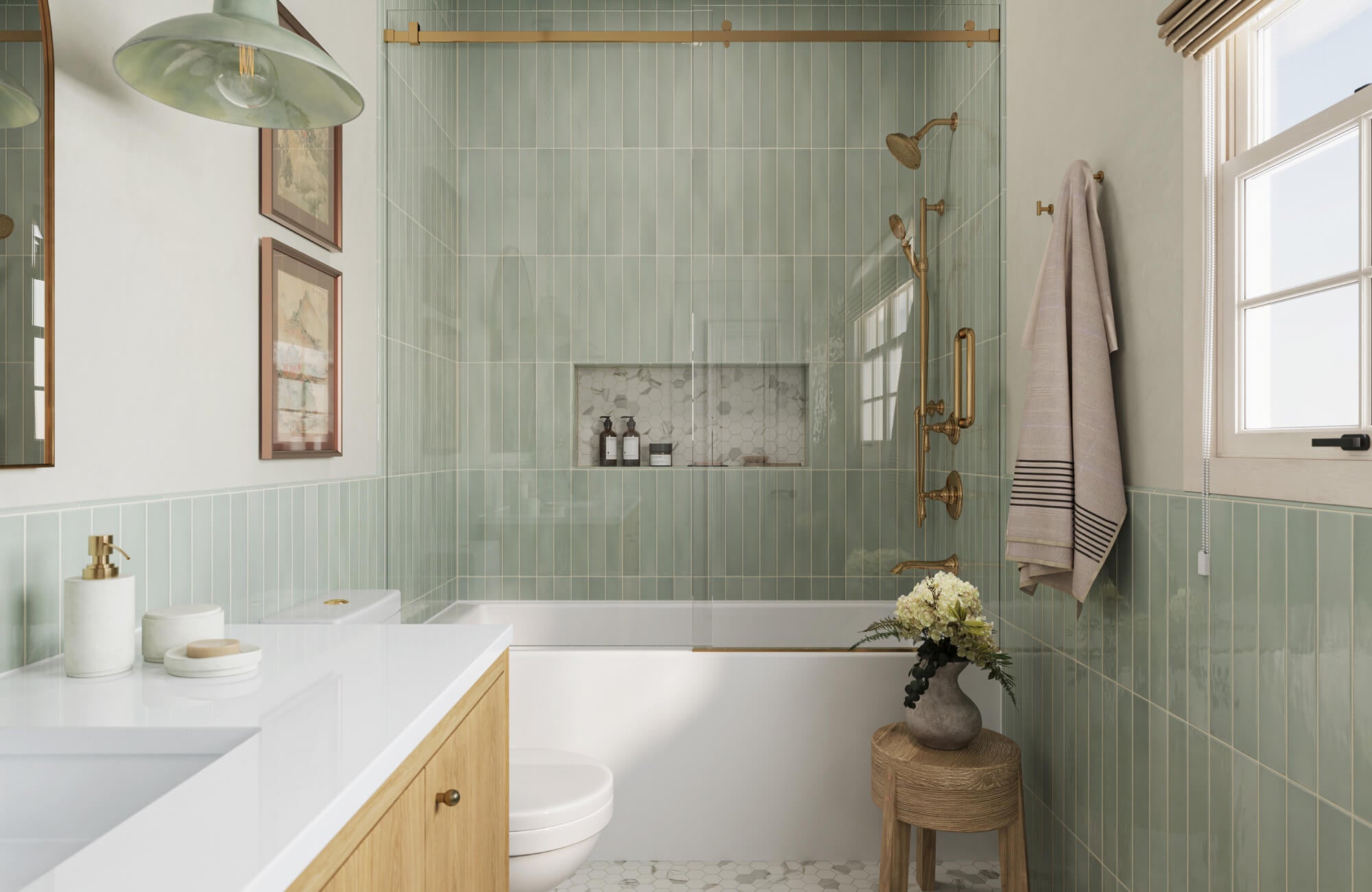 null A calming bathroom renovation featuring soft sage-green vertical tiles, warm brass fixtures, light wood cabinetry, and creamy white surfaces that create a fresh, soothing, and subtly elegant color palette.