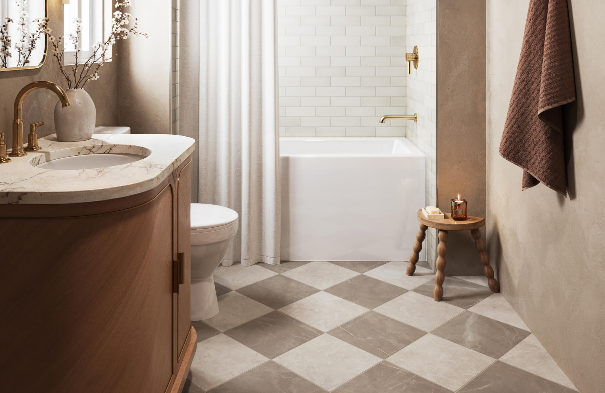 null Warm-toned bathroom with beige and taupe checkerboard tile flooring, curved wood vanity, gold fixtures, and a small wooden accent stool.