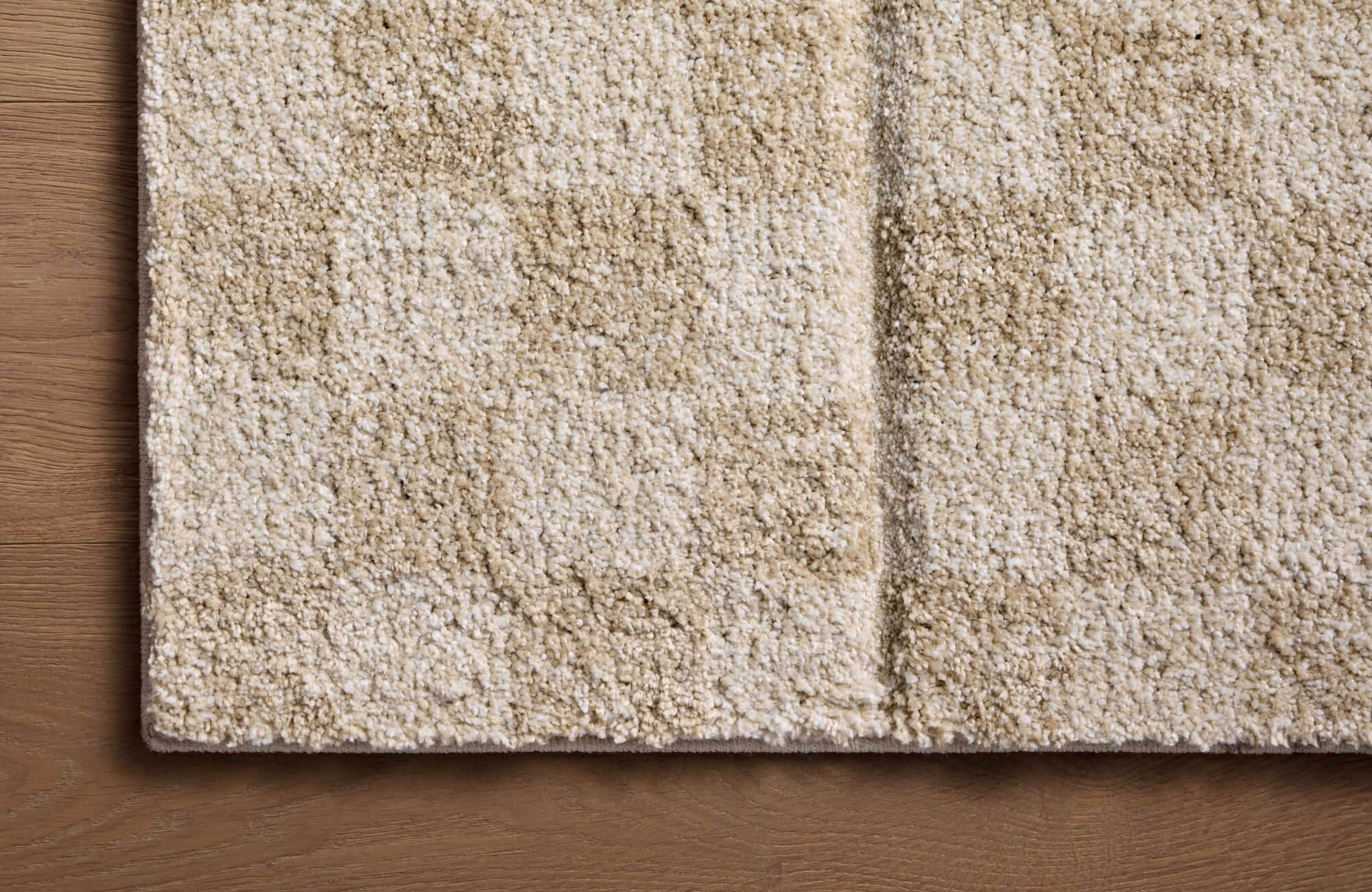 null Plush polypropylene area rug with a subtle checkerboard pattern in warm beige and ivory tones, adding softness and durability.