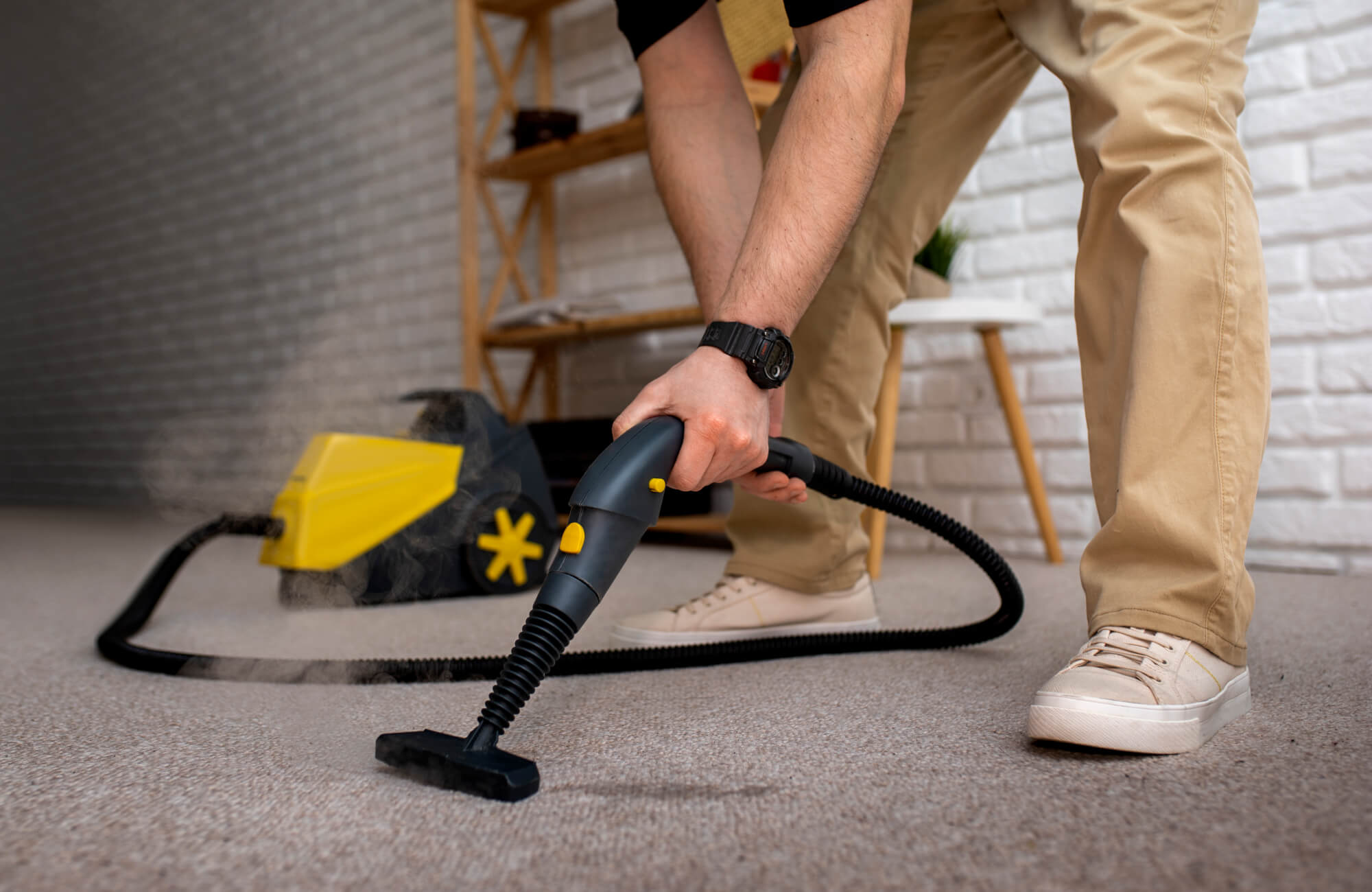 null Person using a steam cleaner on a polypropylene carpet, deep-cleaning the fibers for a fresh and sanitized look in a modern living space.