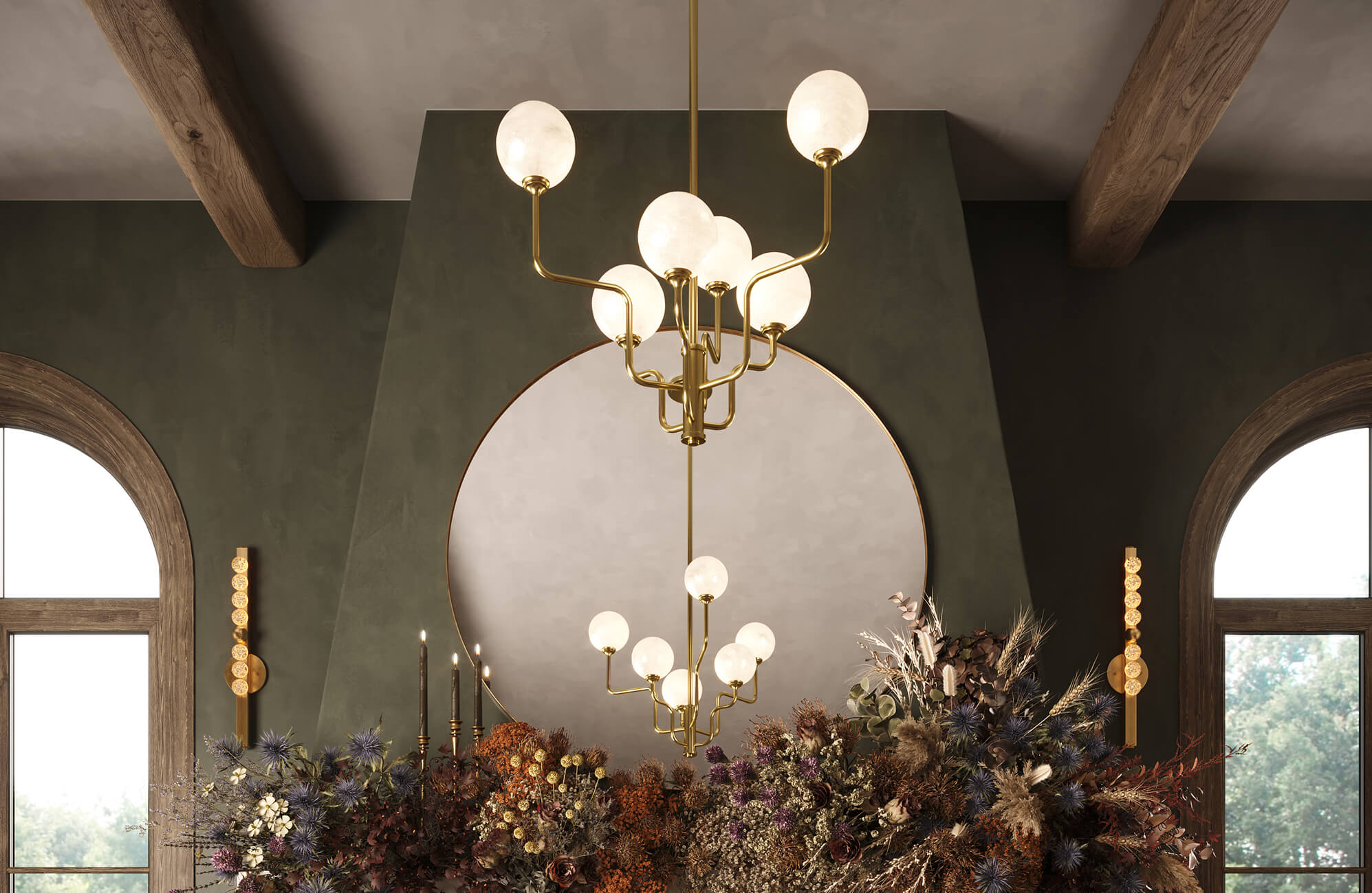 null Sophisticated interior showcasing a sculptural gold chandelier with spherical frosted glass shades, beautifully reflected in a large round mirror above a mantel adorned with lush, dried floral arrangements.