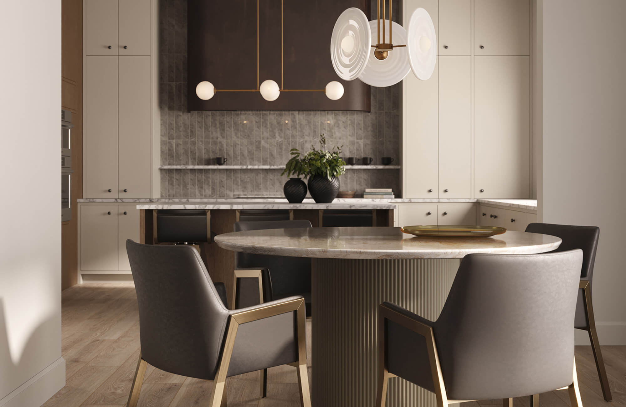Black upholstered dining chairs with brass accents surround a marble table, balanced by soft lighting and light cabinetry in a modern kitchen space.