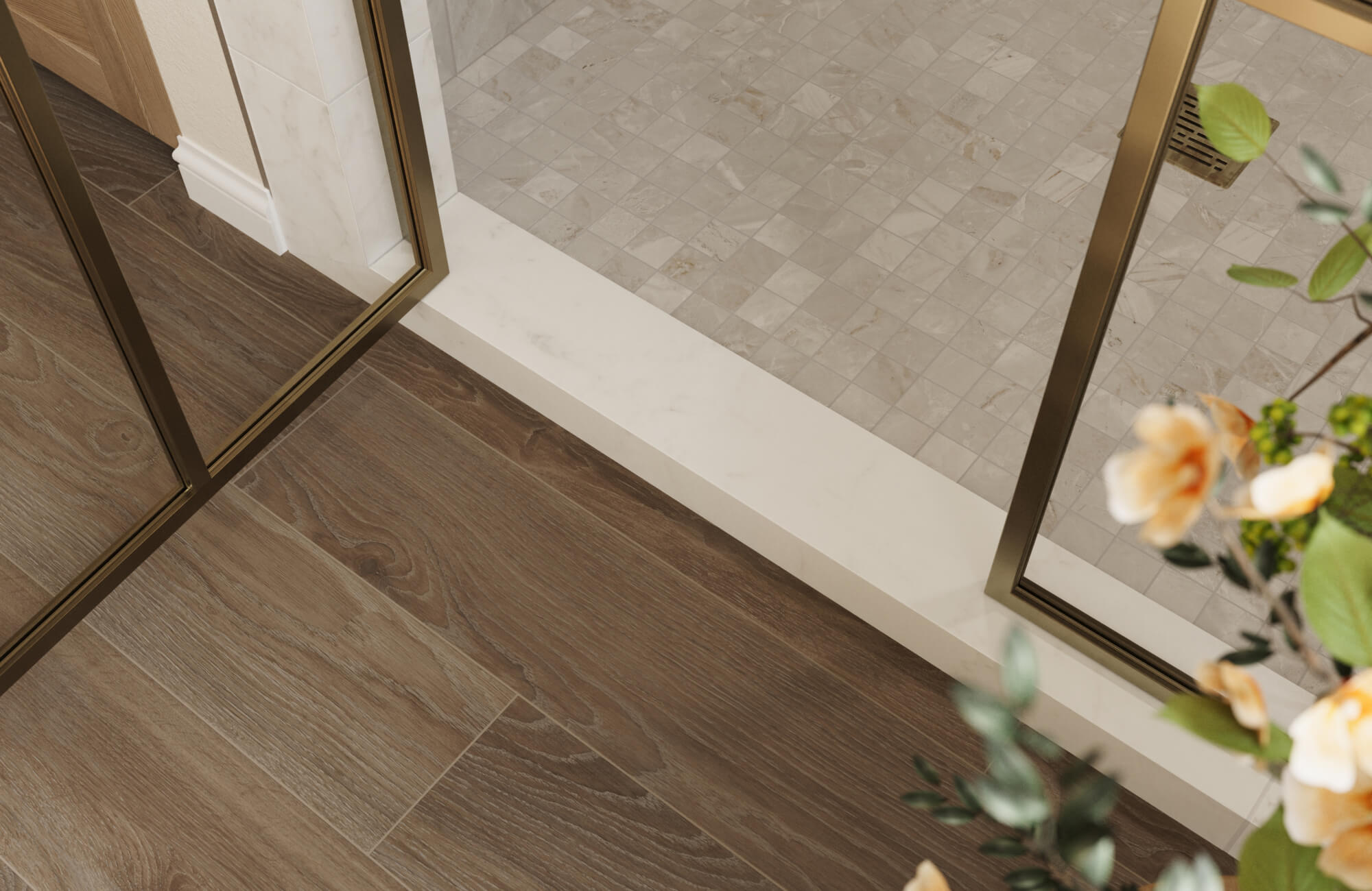 null Marble threshold between dark wood flooring and tiled shower area, highlighting a clean transition strip and framed glass enclosure.