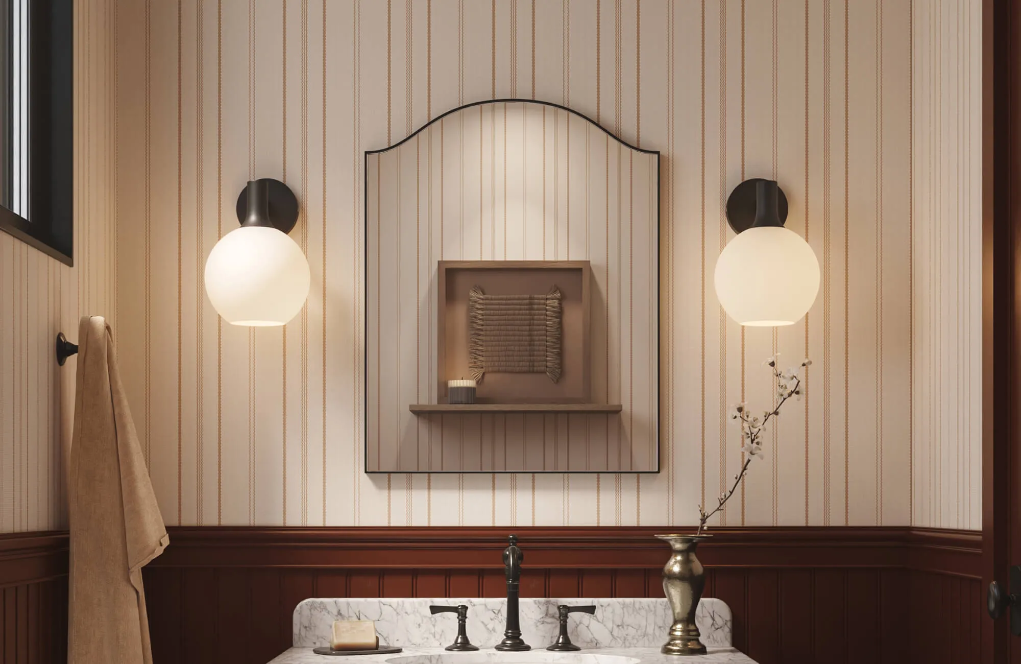 Delicate striped wallpaper paired with rich wood wainscoting, mirror, and sconces brings subtle height and tailored elegance to this warm, vintage-inspired bathroom.