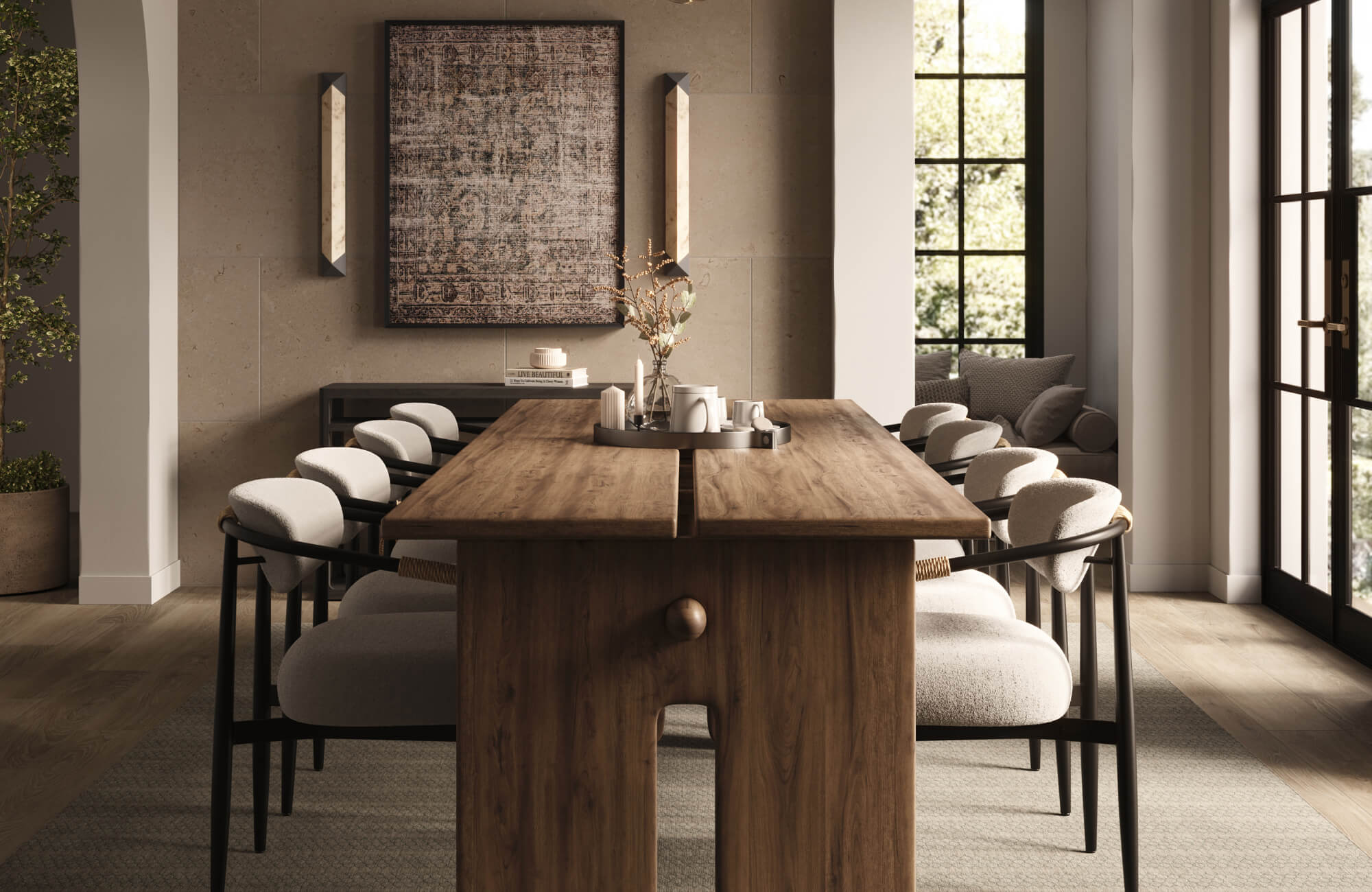 Warm modern dining room with a solid wood table, upholstered chairs, large framed wall art, and neutral stone tile walls.