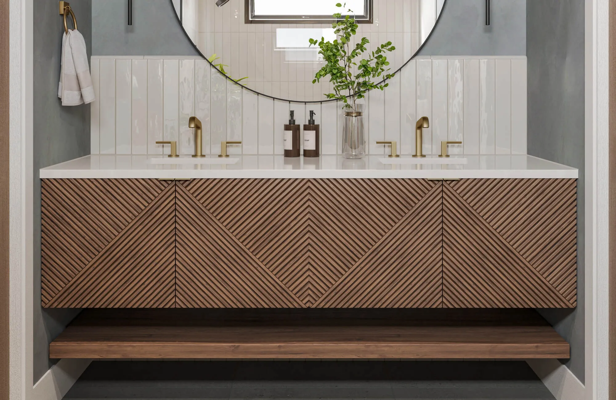 Modern double sink vanity with white vertical tile backsplash and geometric wood paneling in a chevron pattern.