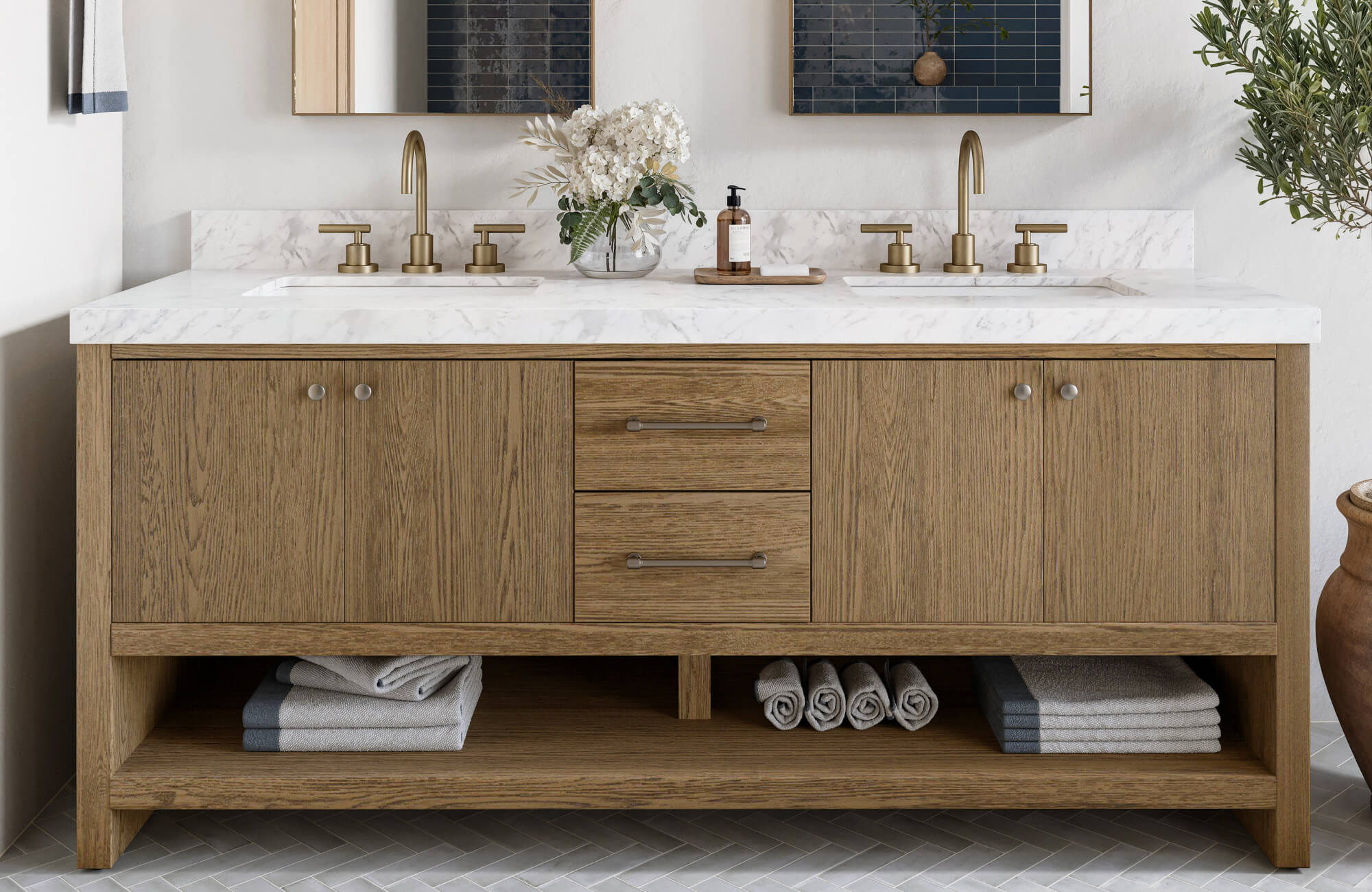 Double sink vanity with warm oak cabinetry, marble countertop, and brushed brass fixtures for a timeless, spa-like look.
