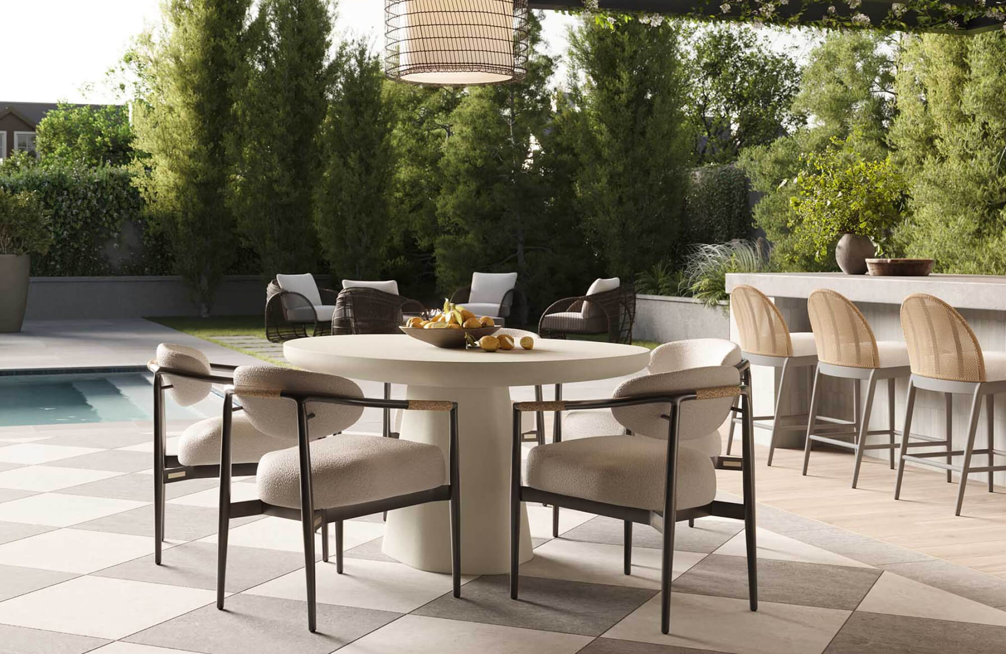 Covered poolside patio with a round dining table, cushioned armchairs, nearby outdoor bar seating, lounge chairs, and garden landscaping.