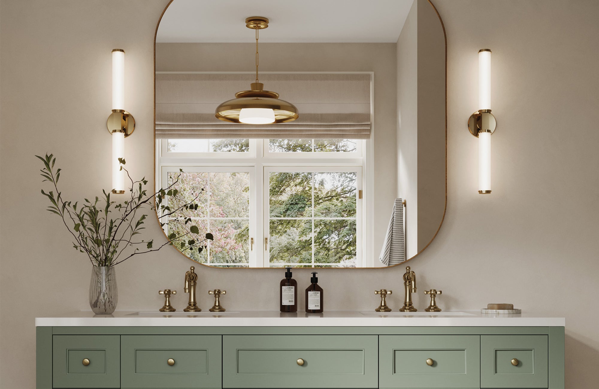 Double vanity with two vertical sconces framing a large mirror for consistent light across both sinks.