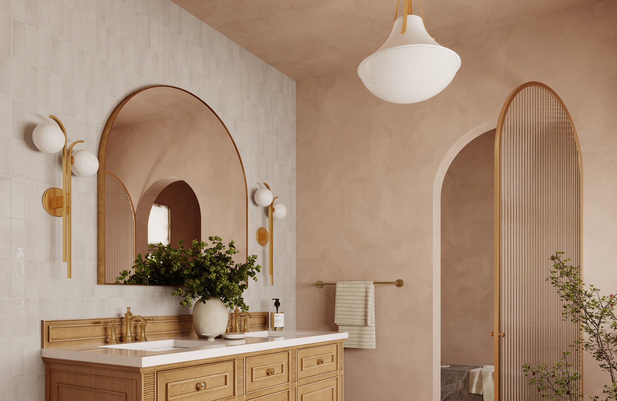 Double vanity with two wall sconces on each side of the arched mirror, creating symmetrical, soft lighting.