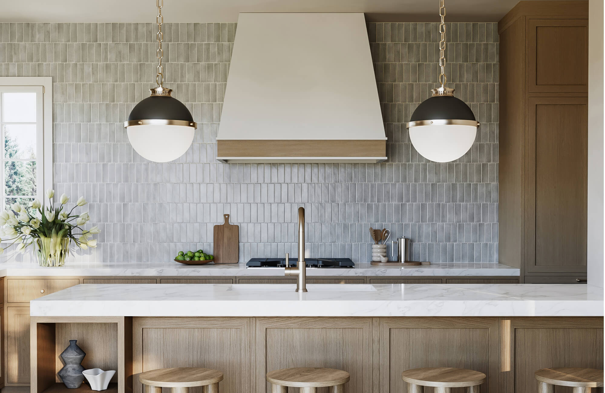 null Matte globe pendant lights hang above a marble island, set against a vertical gray tile backsplash and light wood cabinetry.
