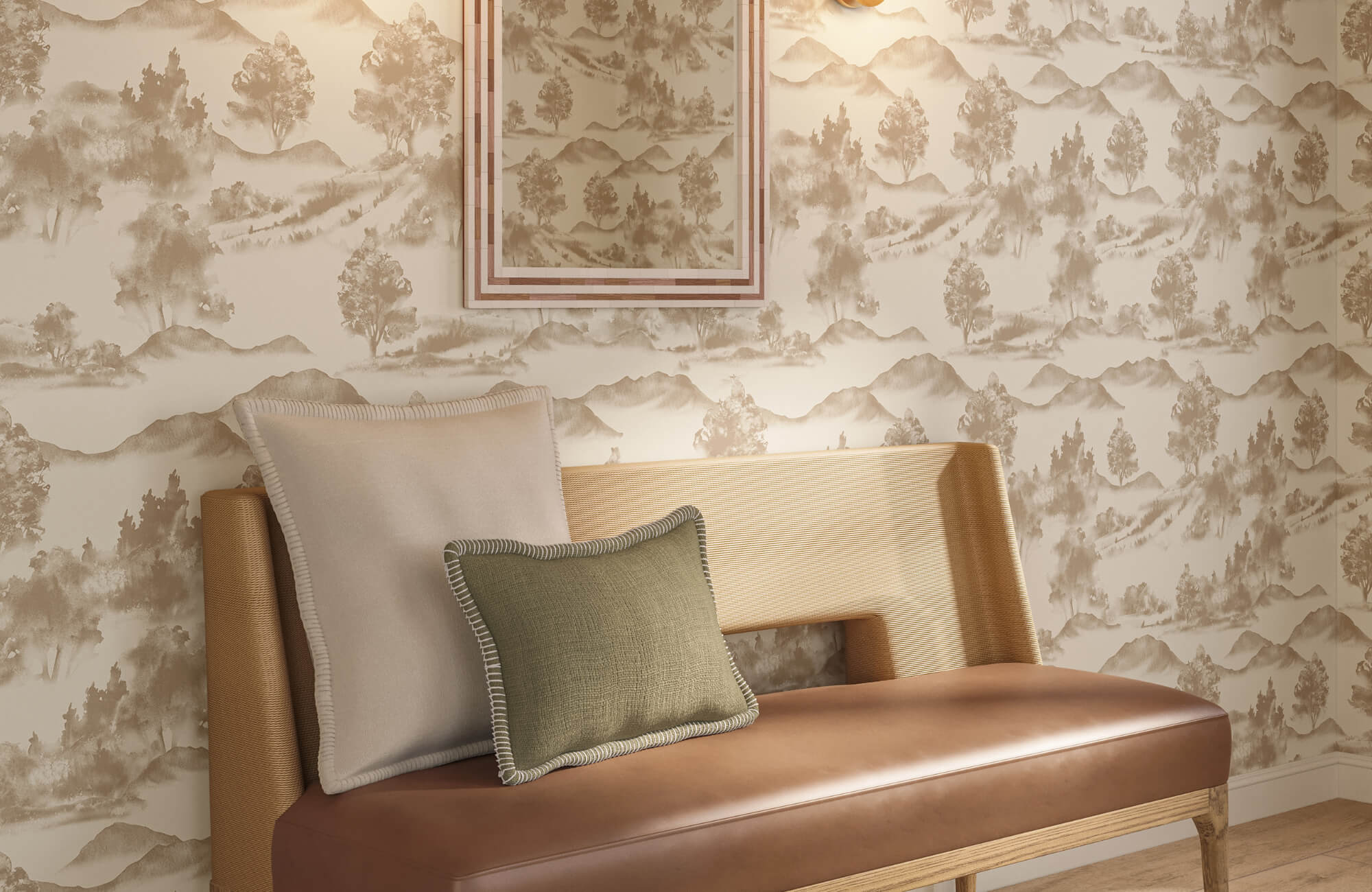 Neutral accent pillows layered on a tan leather bench against scenic taupe wallpaper in a warm interior.