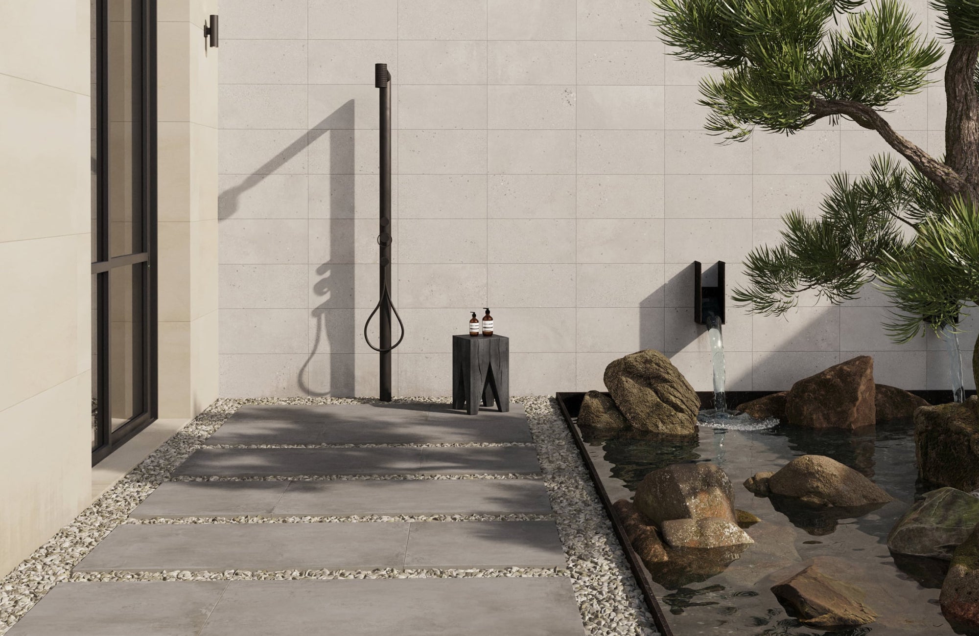 Outdoor porcelain tiles laid as pathway slabs beside a shower and water feature, sleek and weatherproof.