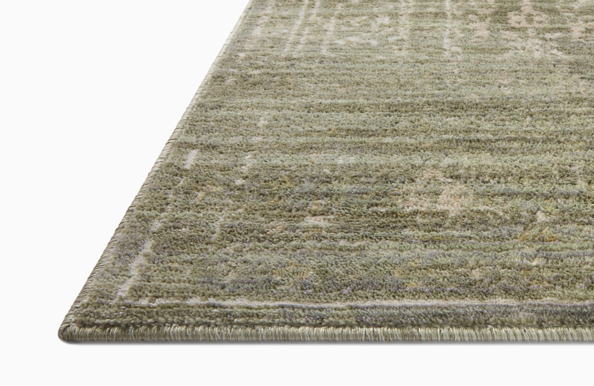 null Plush area rug in soft sage green with a subtle vintage pattern, offering a timeless and elegant touch to any space.