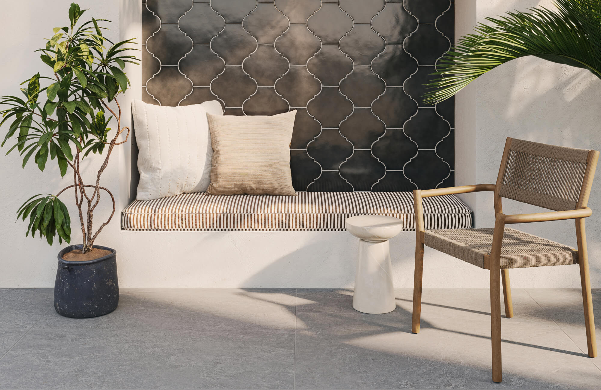 Natural wood and woven outdoor chair placed next to a built-in bench with striped cushioning, creating a relaxed patio seating area with decorative tile and greenery.