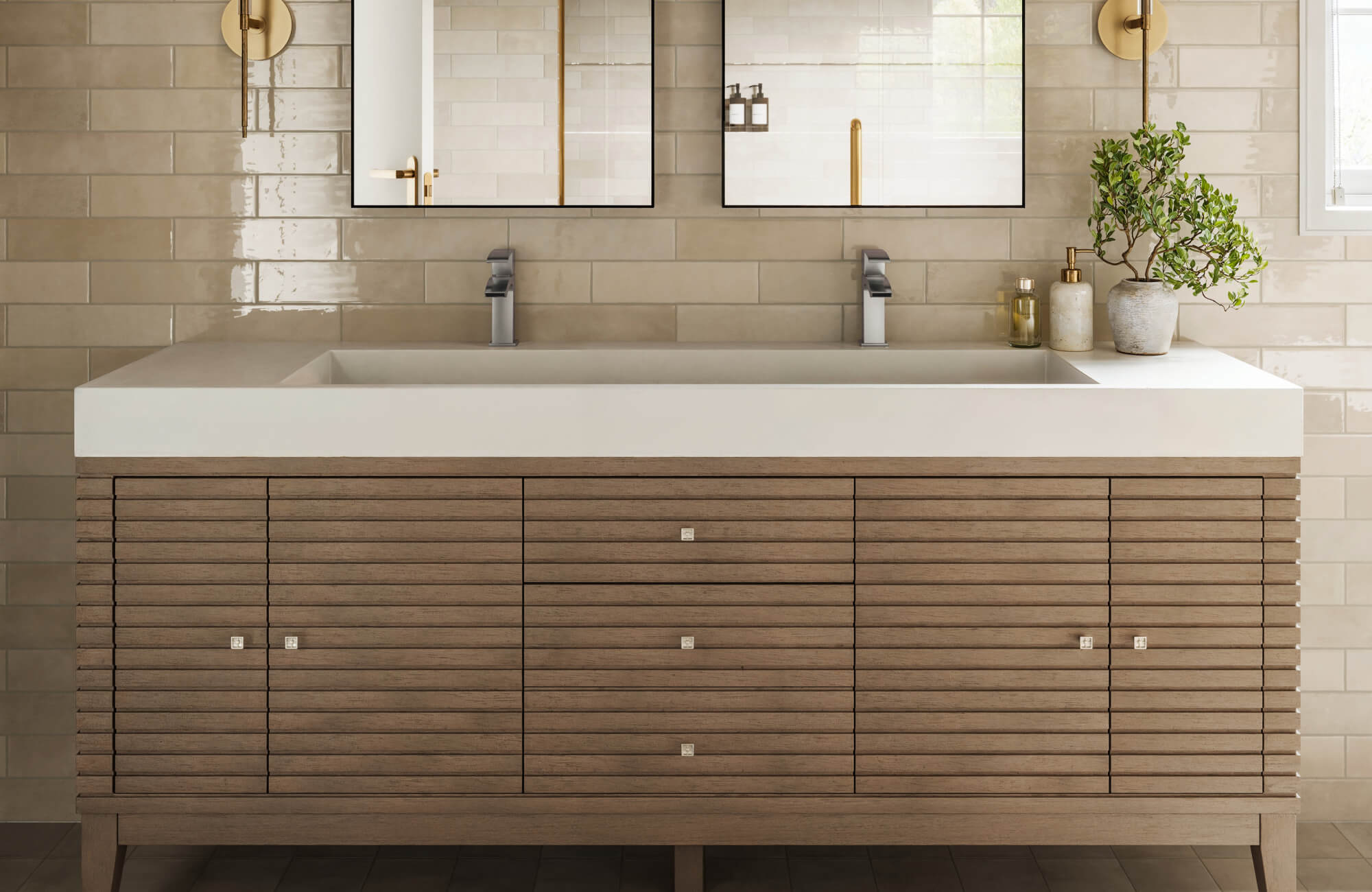 Modern vanity with dark wood cabinetry and marble countertop, paired with brass fittings and soft beige wall tile for a warm, classic look.