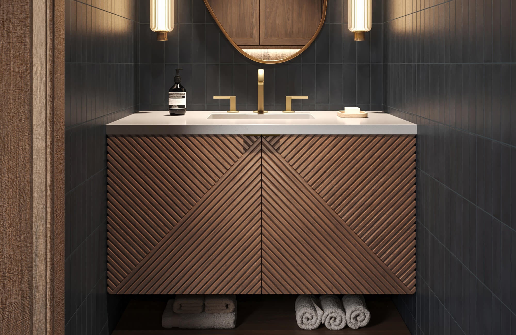 Floating bathroom vanity featuring diagonal wood slats, gold-tone faucet, and under-cabinet towel storage, set against deep navy wall tiles.