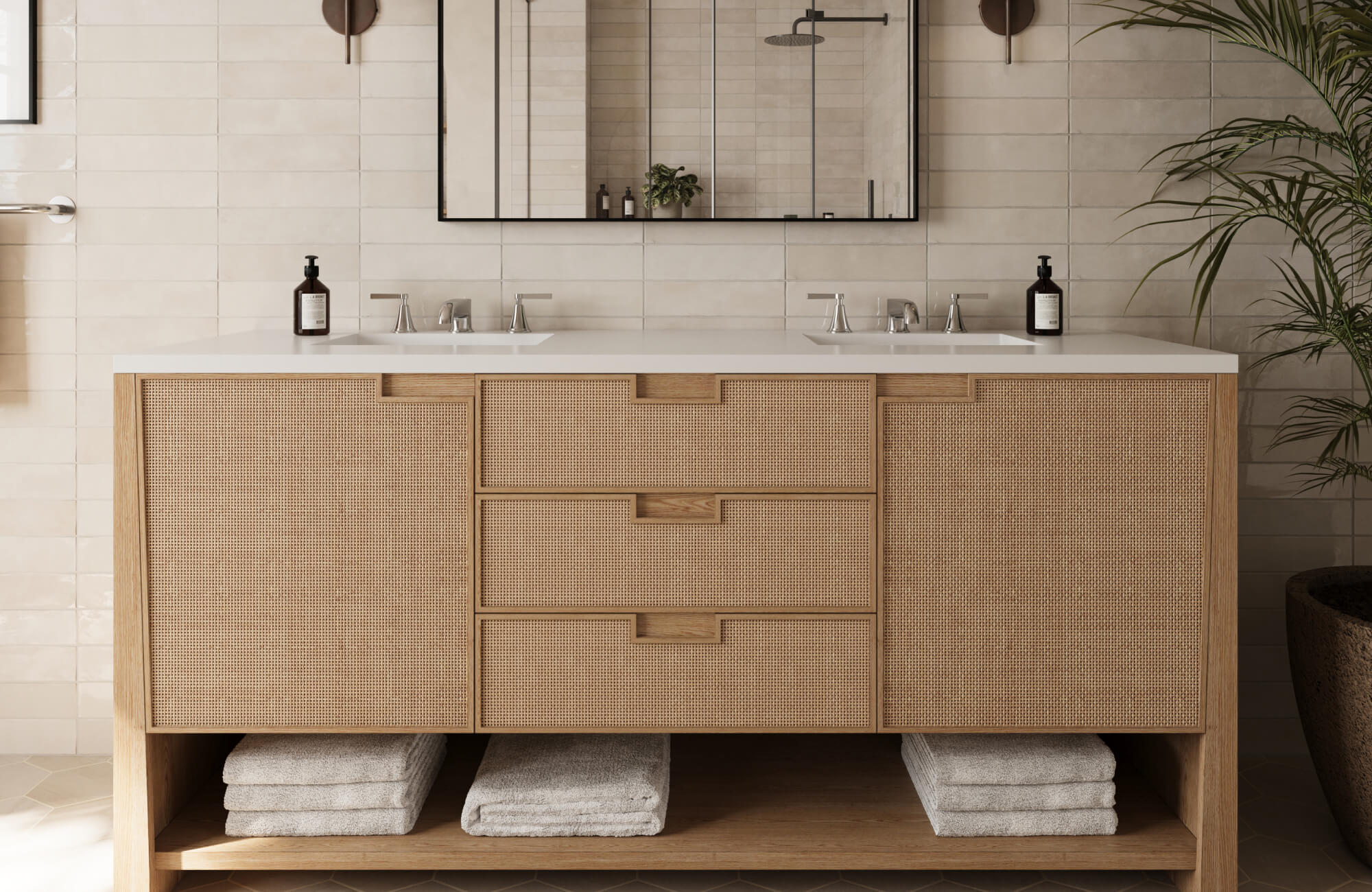 Natural wood vanity with textured cabinet faces and dual sinks, styled with stacked towels and a large mirror in a neutral bathroom.