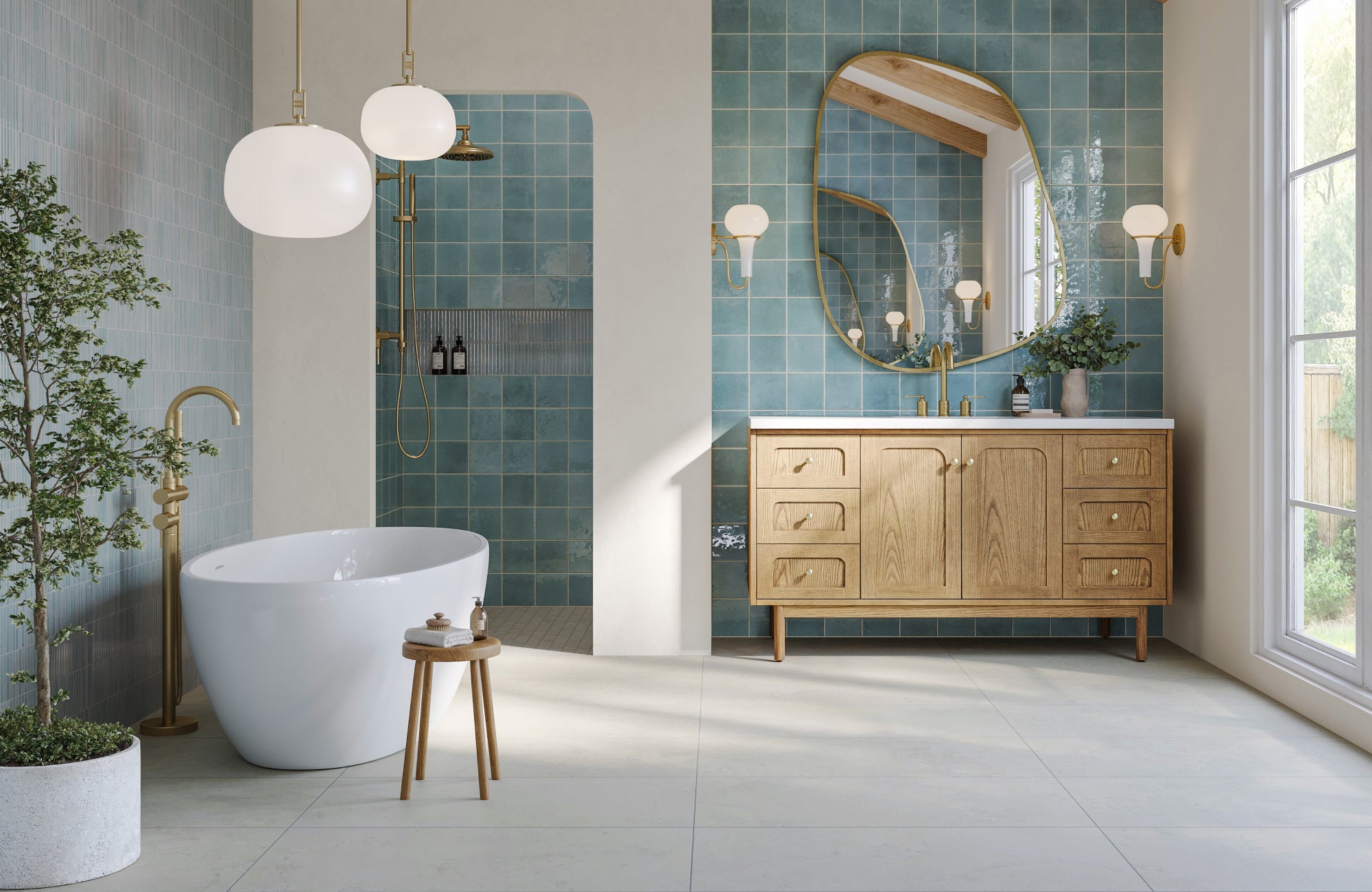 Elegant bathroom featuring a freestanding tub and an irregular brass mirror creating a stylish focal point.