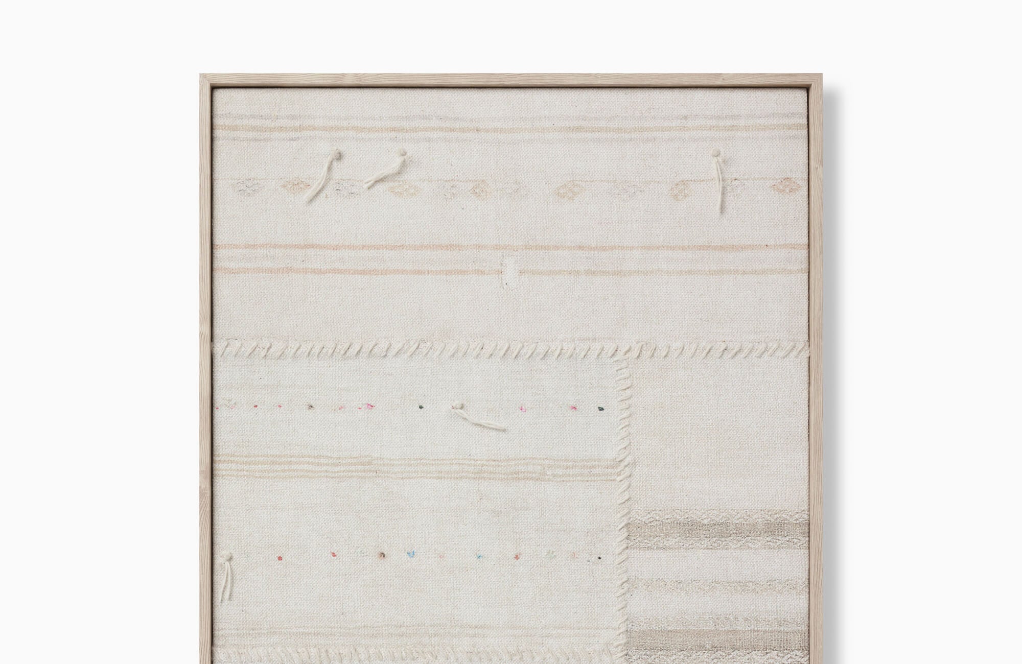 null Neutral framed textile wall art with subtle woven stripes, stitched details, and a pale wood frame on a white background.
