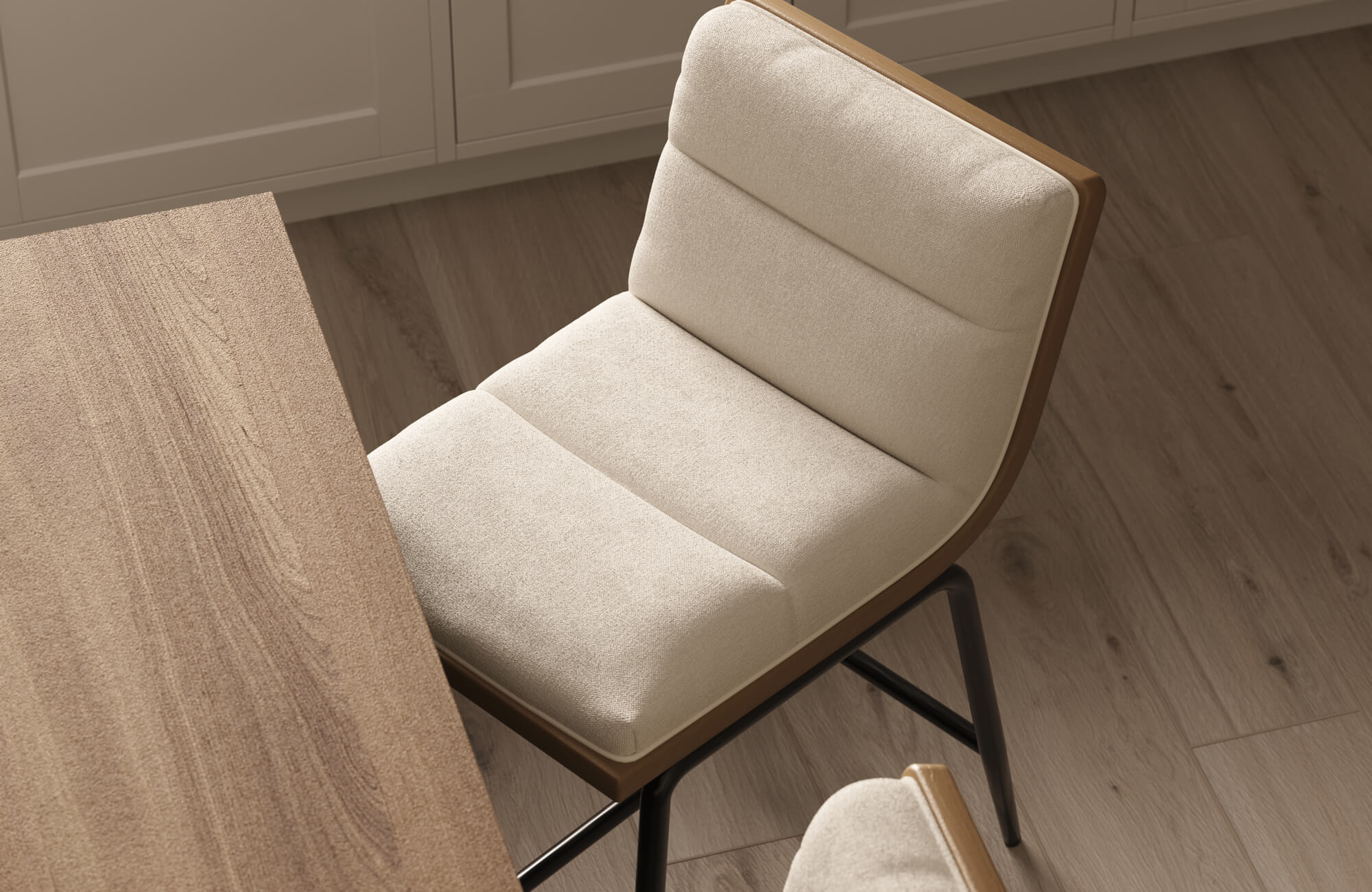 null Beige cushioned stool with a contoured wooden backrest and black metal base, shown next to a natural wood countertop in a light-toned kitchen.