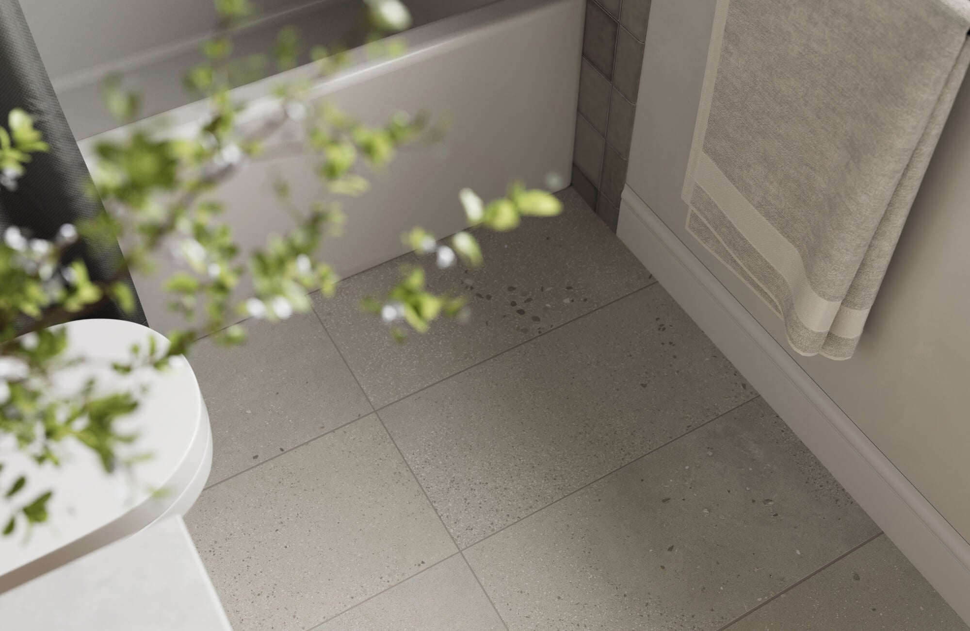 Modern bathroom floor finished with gray terrazzo tiles, highlighting natural texture and understated pattern variation.