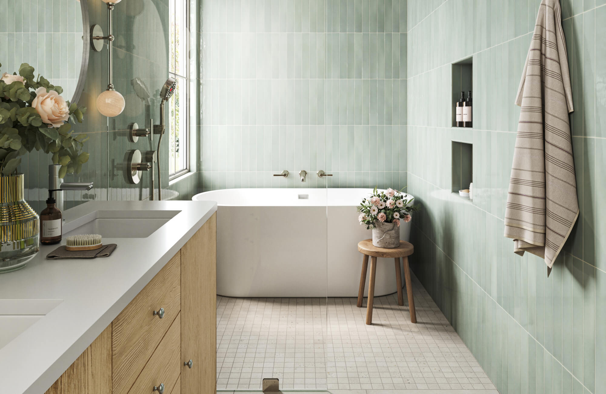 Soft green tiled bathroom with a built-in soaking tub, light wood vanity, and small-format floor tiles for a calm, modern feel.