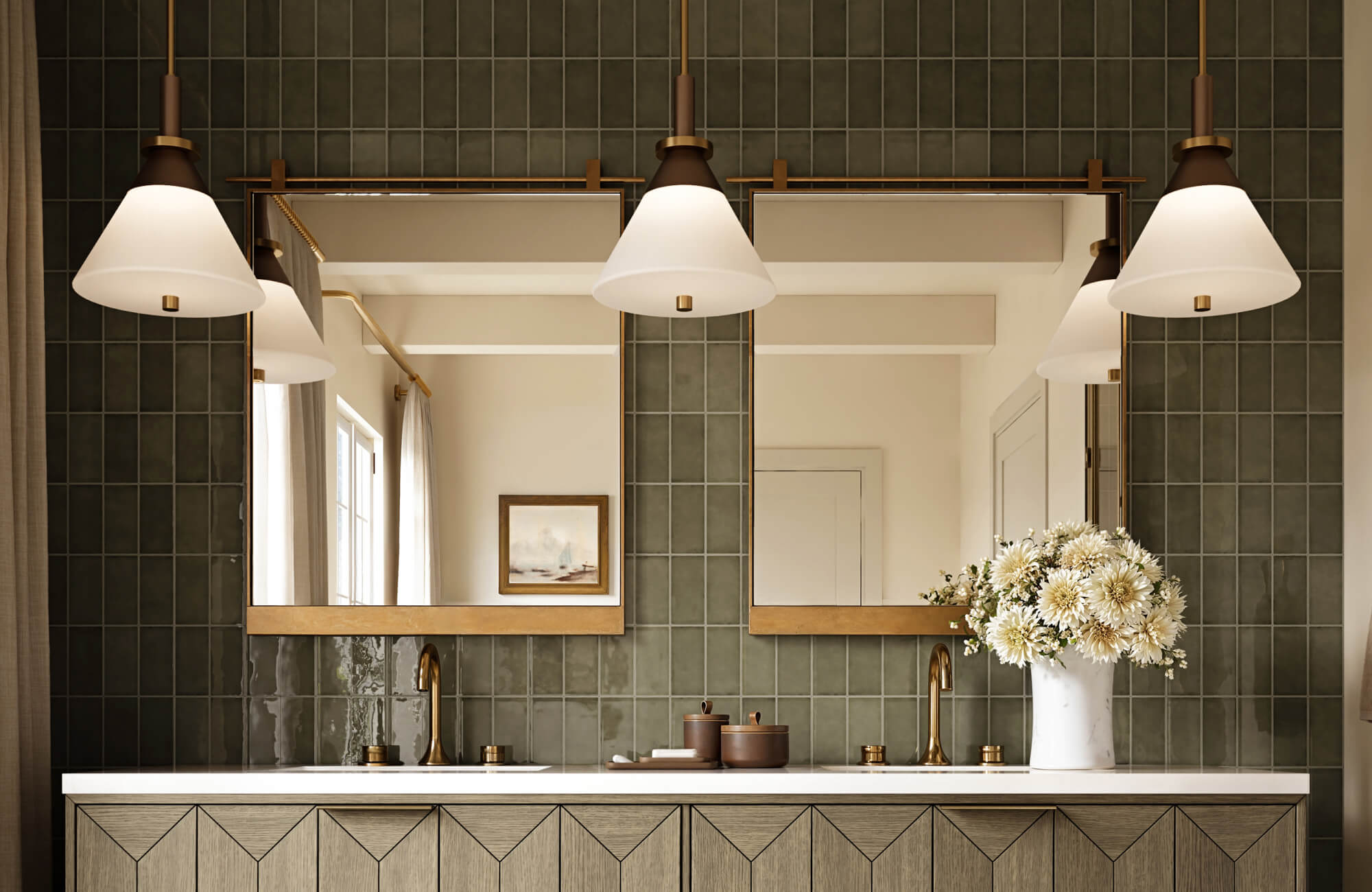Double vanity bathroom with green tiled walls, gold-framed mirrors, and warm brass lighting, creating a balanced and refined modern look.