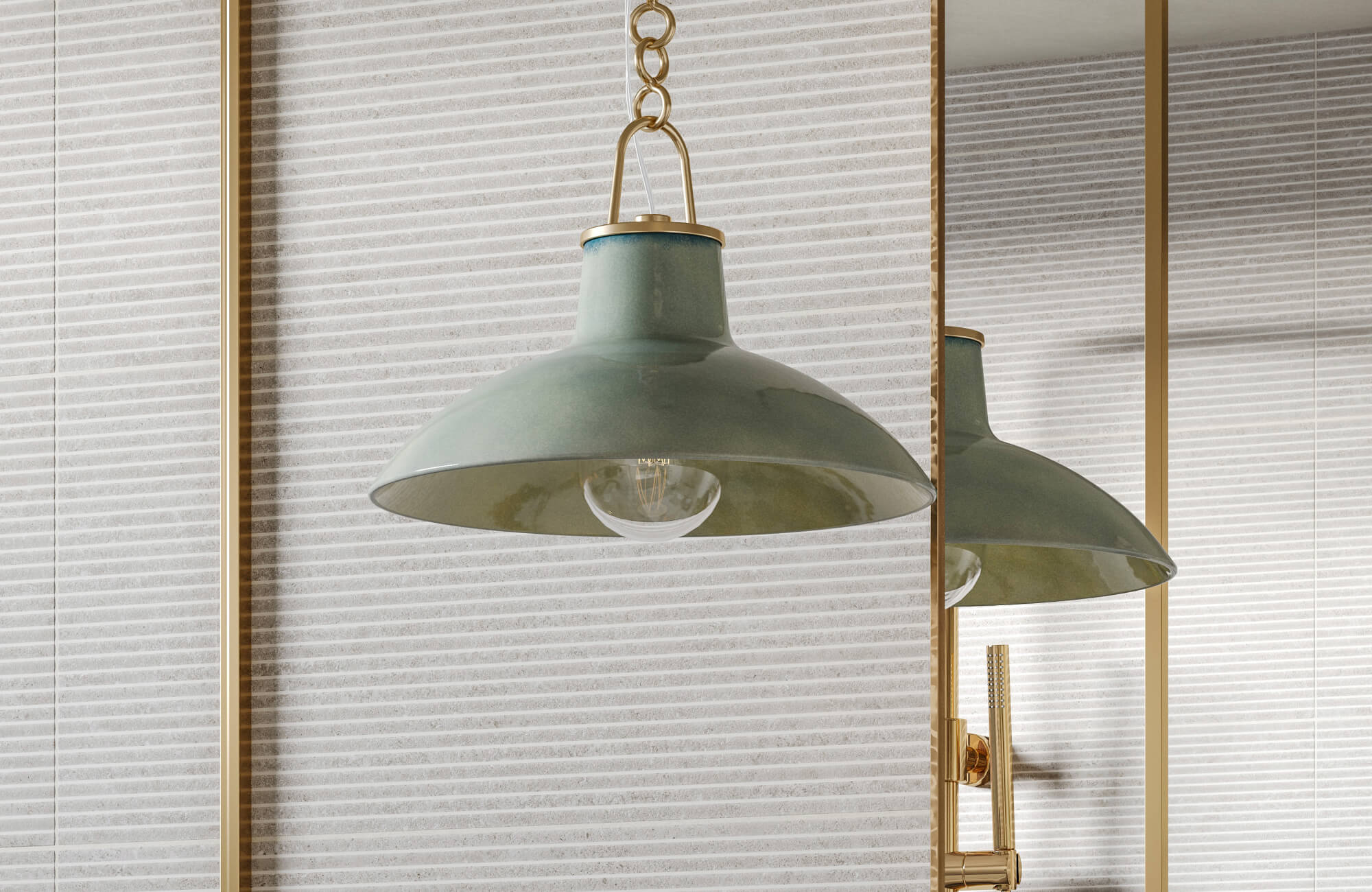 Close-up of a green pendant lamp with brass details, adding warm lighting against a striped wall tile backdrop.
