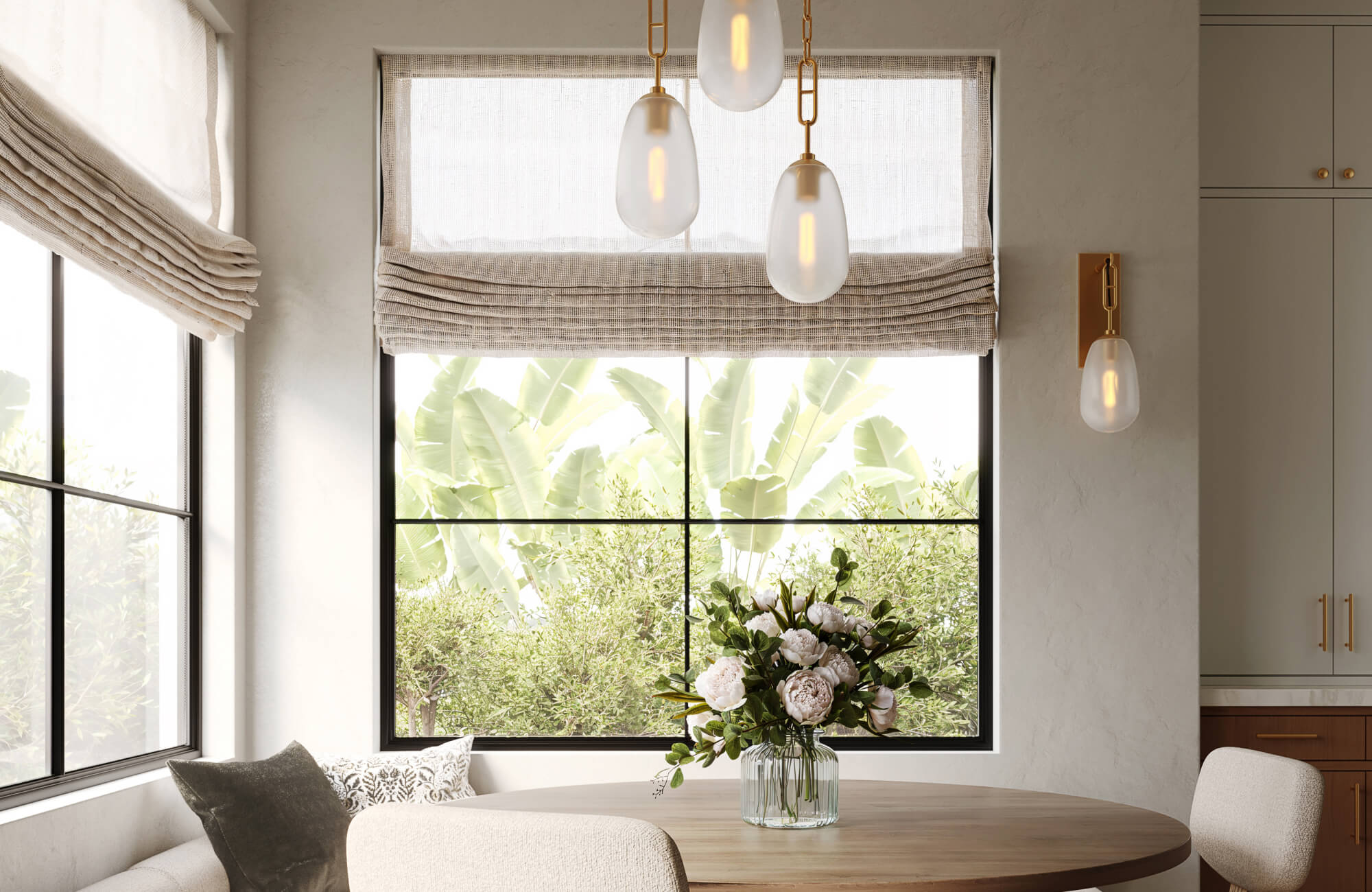 null Bright dining nook featuring layered light through abundant natural sunlight, soft-glow pendant fixtures, and a sleek wall sconce, creating an inviting ambiance that blends warmth, texture, and modern elegance.