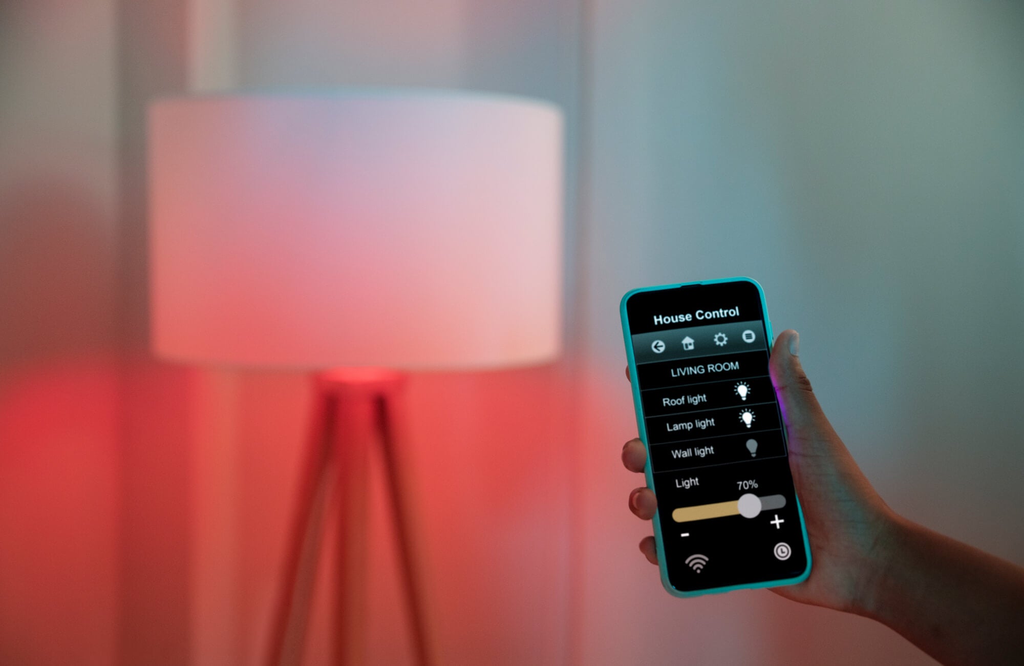 null Modern smart home setup featuring layered light control via a mobile app, adjusting ambient, task, and accent lighting for a sleek tripod floor lamp that glows in warm red tones, creating a customizable and dynamic atmosphere.