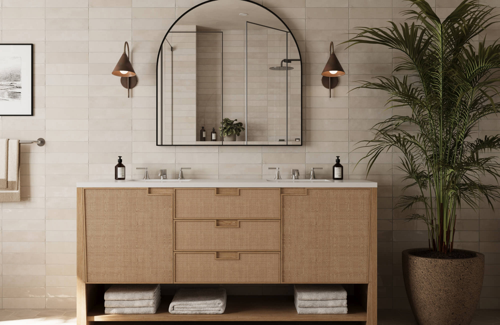 Natural wood vanity with rattan fronts pairs elegantly with bronze cone sconces and a bold arched mirror.